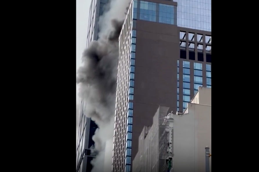 Fire and smoke comes was seen billowing out of a luxury apartment building in Manhattan on Thursday