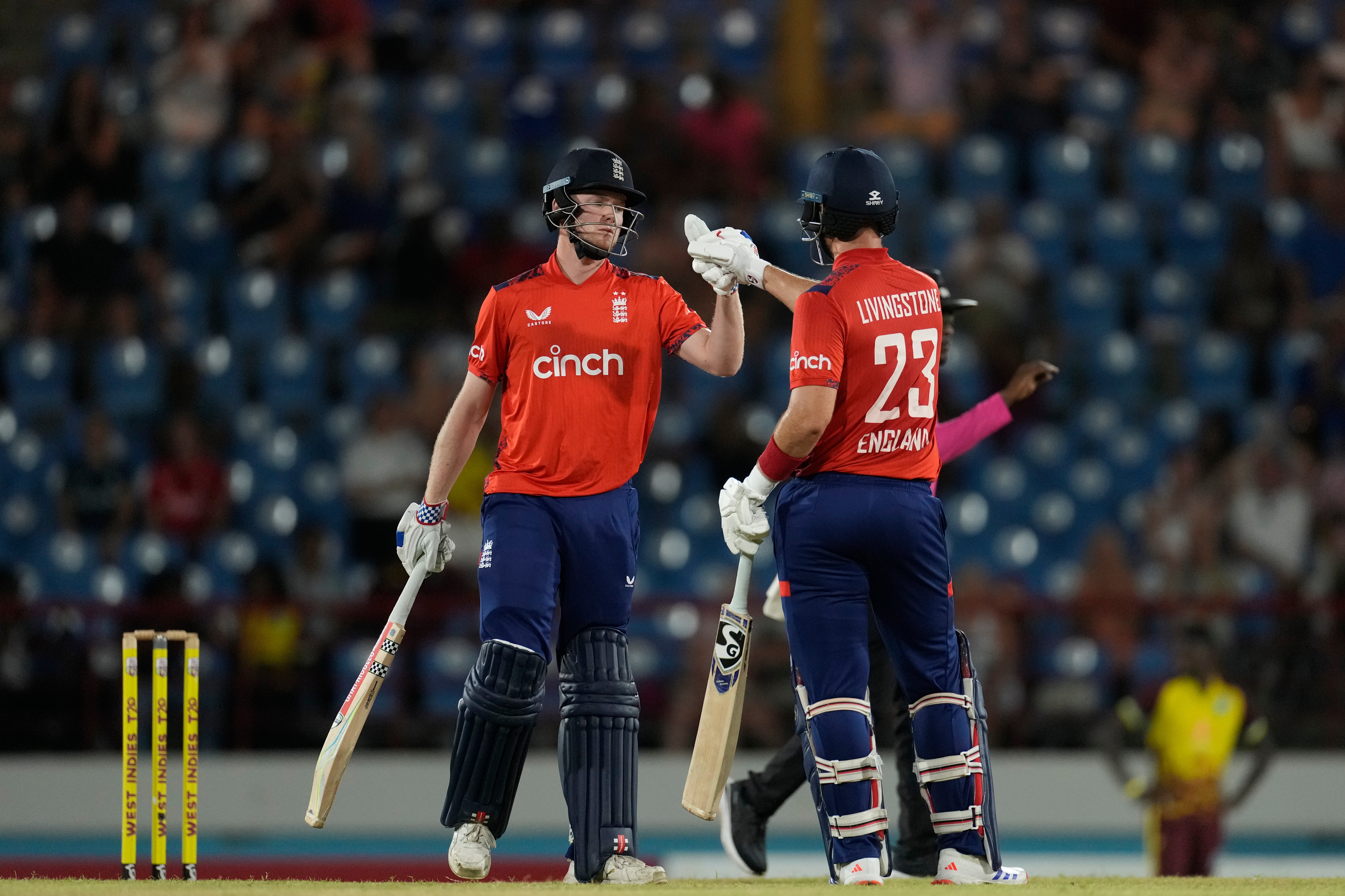 England’s batsmen Dan Mousley, left, and Liam Livingstone knock gloves during their partnership in the third T20 cricket match at Daren Sammy National Cricket Stadium (Ricardo Mazalan/AP)