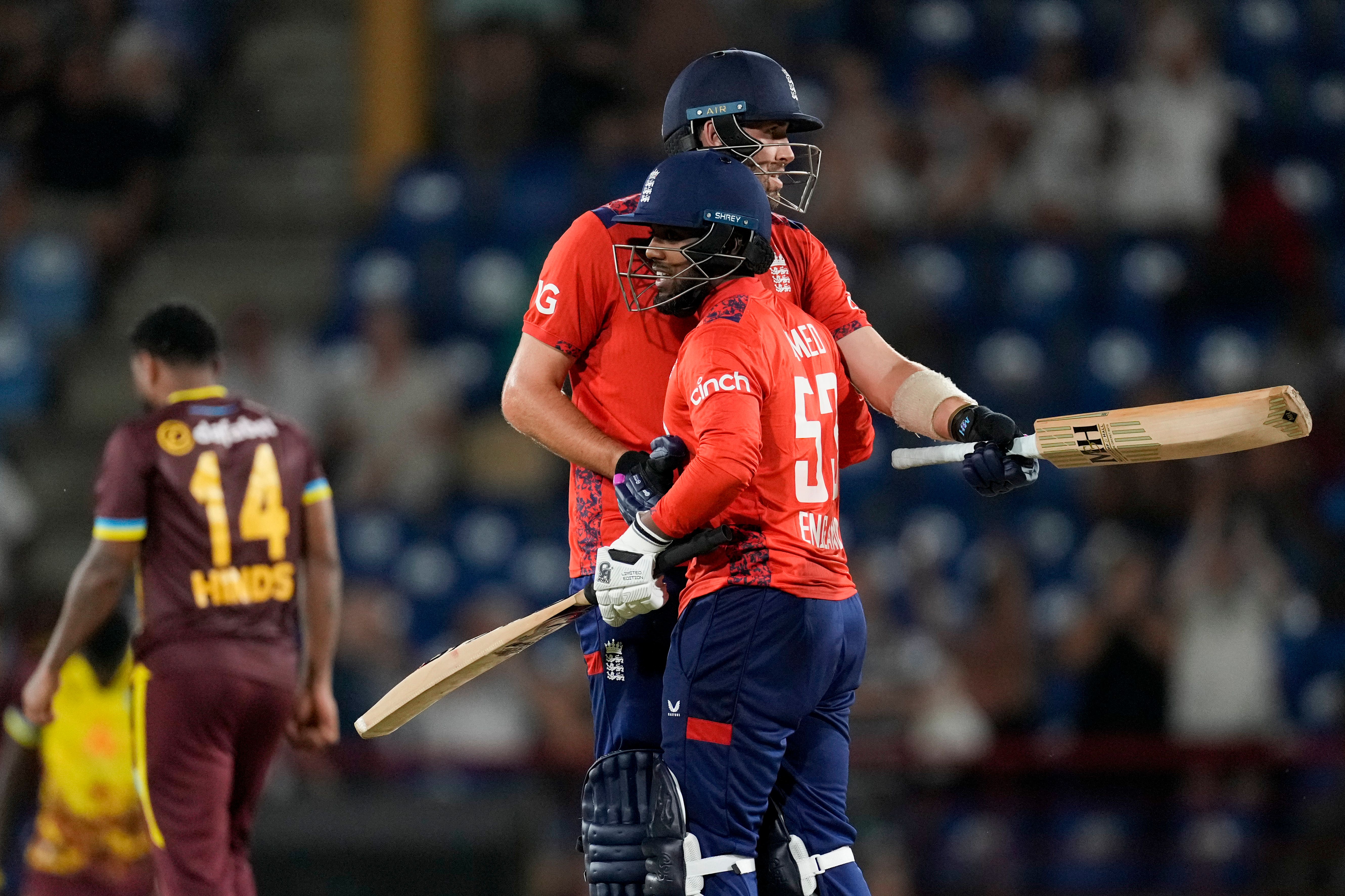 England’s Jamie Overton, center, and Rehan Ahmed celebrated defeating West Indies by 3 wicket with 3 balls remaining (Ricardo Mazalan/AP)