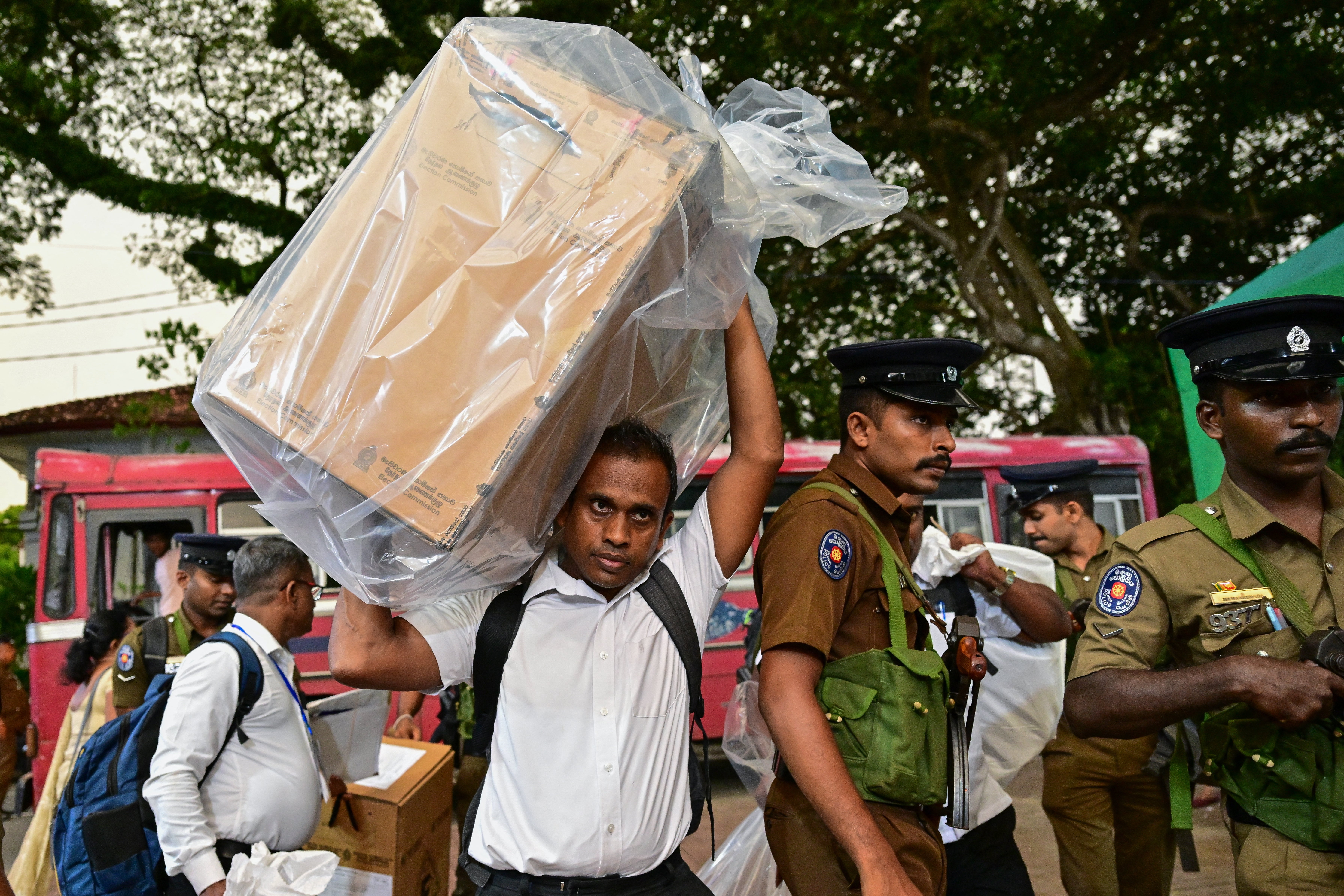 An election official transports a sealed ballot box to a counting centre at the end of voting in Sri Lanka’s legislative elections in Colombo on 14 November 2024