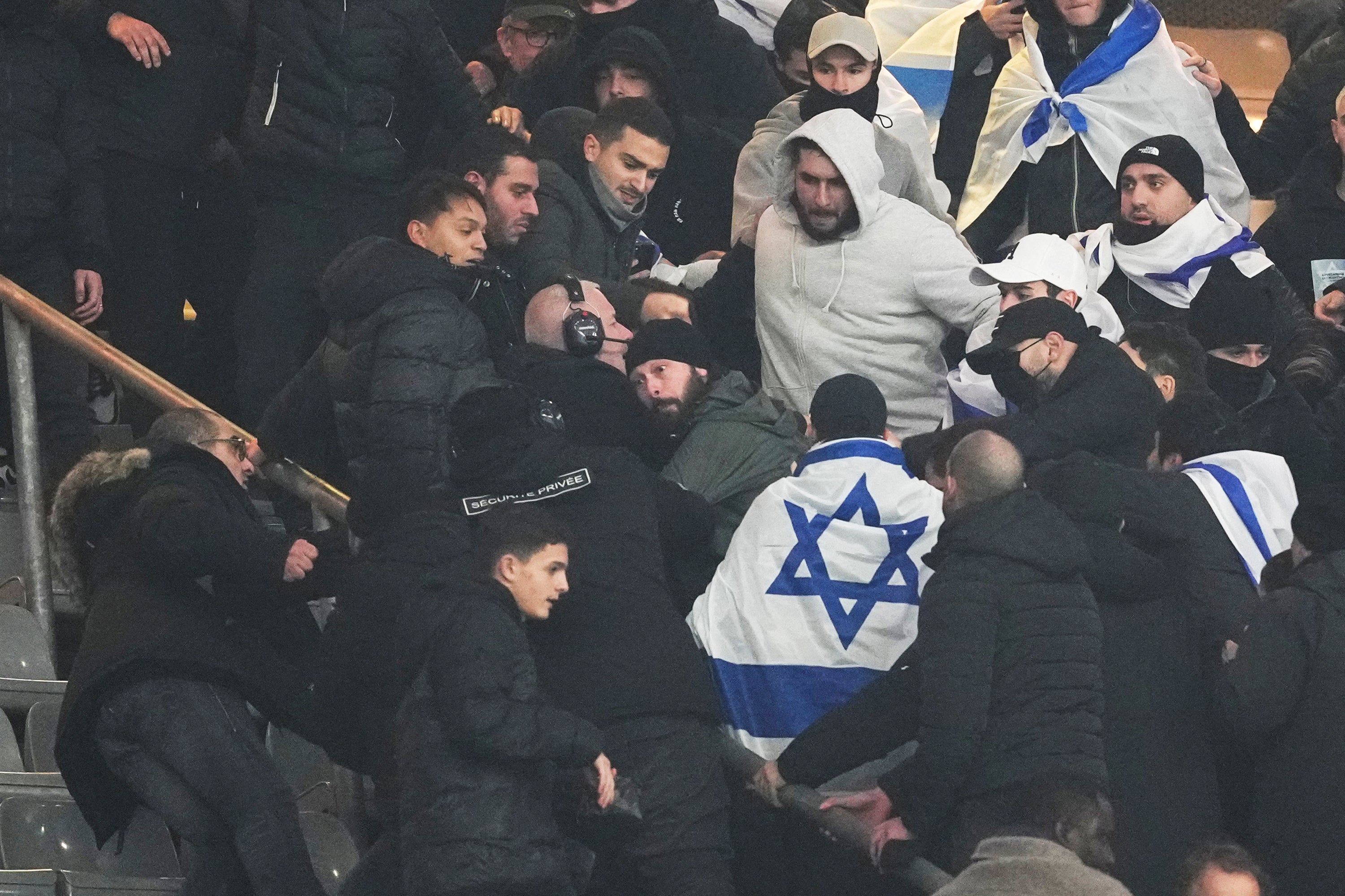 Fans argue on stands during the Nations League soccer match between France and Israel at the Stade de France stadium in Saint-Denis, outside Paris, Thursday, 14 November 2024