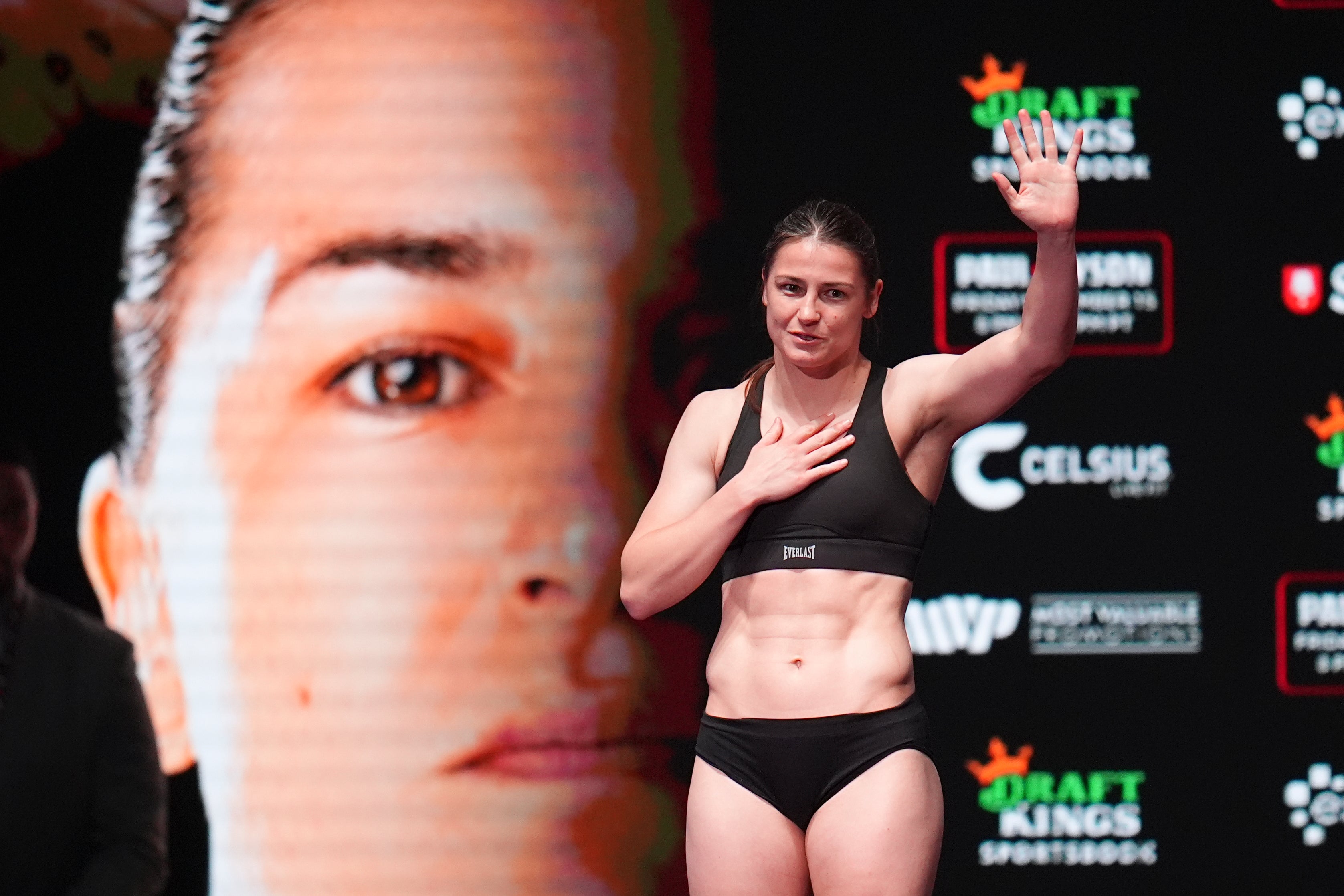 Katie Taylor steps on the scale during her weigh-in (Julio Cortez/AP)