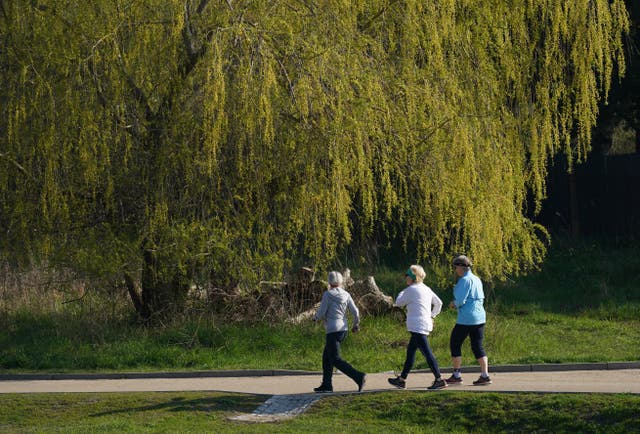 <p>Elderly women walk at a fast pace in a park in Berlin</p>