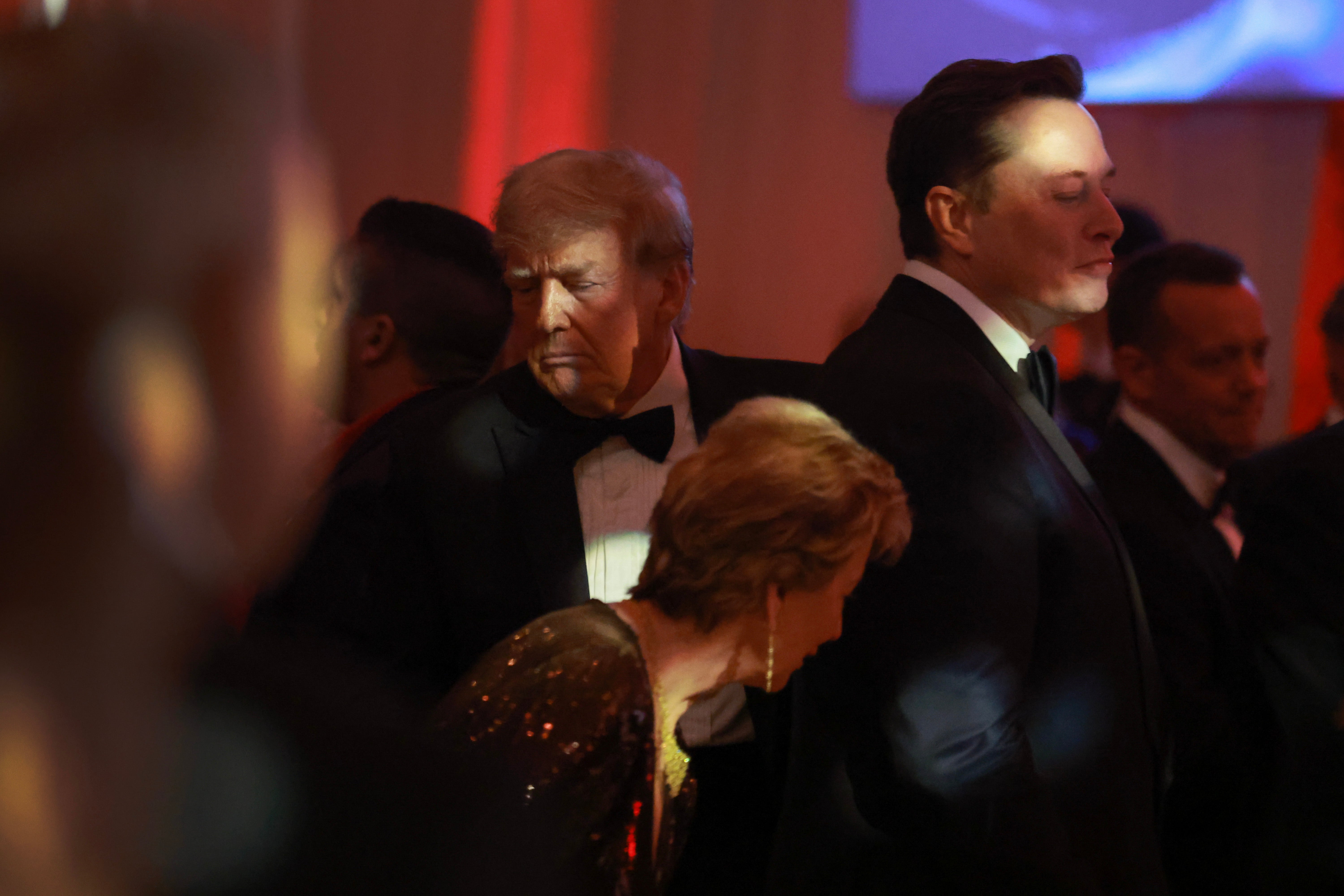 Donald Trump walks past Elon Musk as they attend the America First Policy Institute Gala held at Mar-a-Lago on November 14, 2024, in Palm Beach, Florida. Some believe their respective social media sites may merge