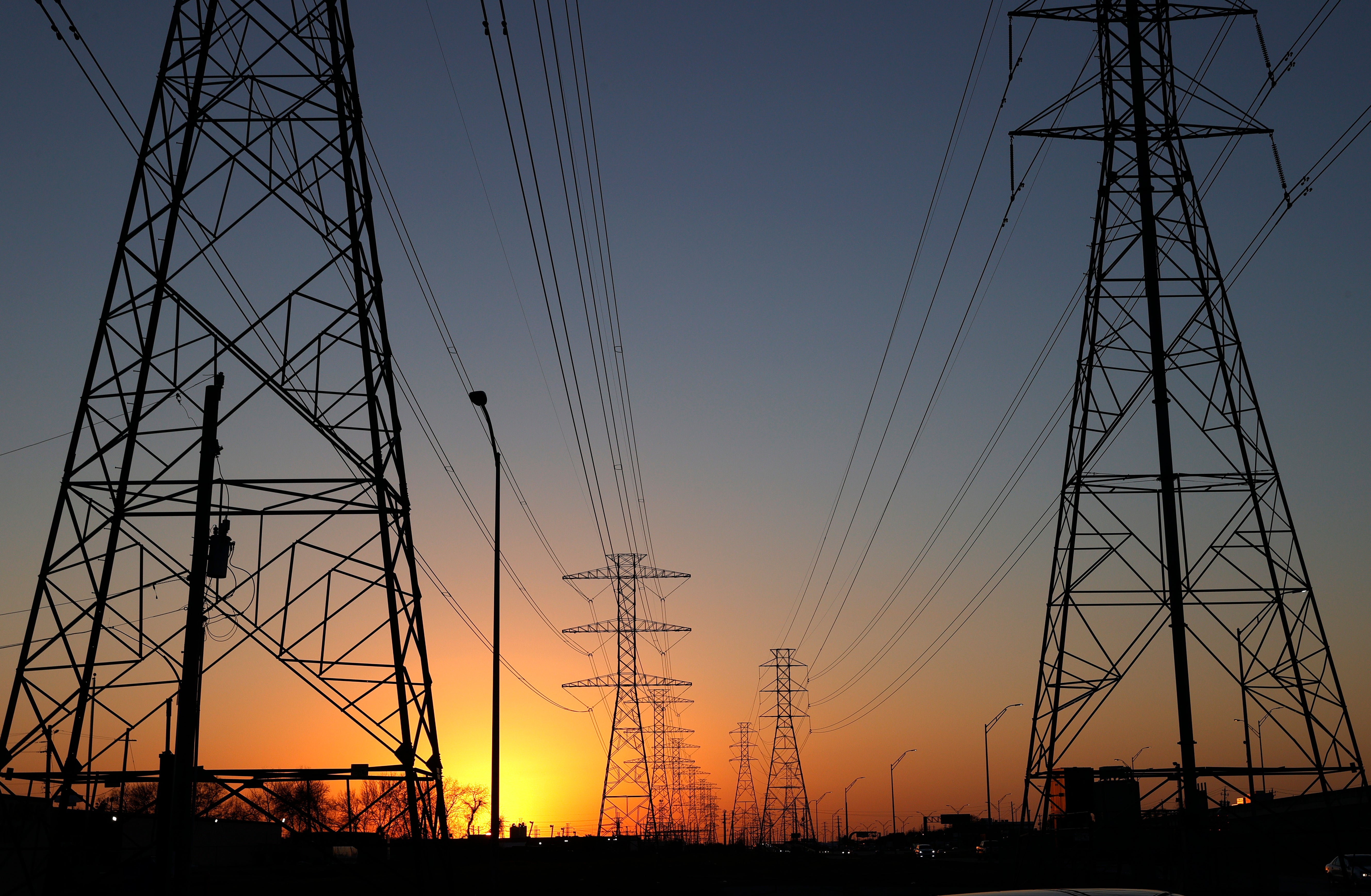 High voltage transmission towers stand in Houston, Texas, on February 21, 2021. Millions of Texans lost their power when Winter Storm Uri hit the state in 2021 and left at least 290 peple dead