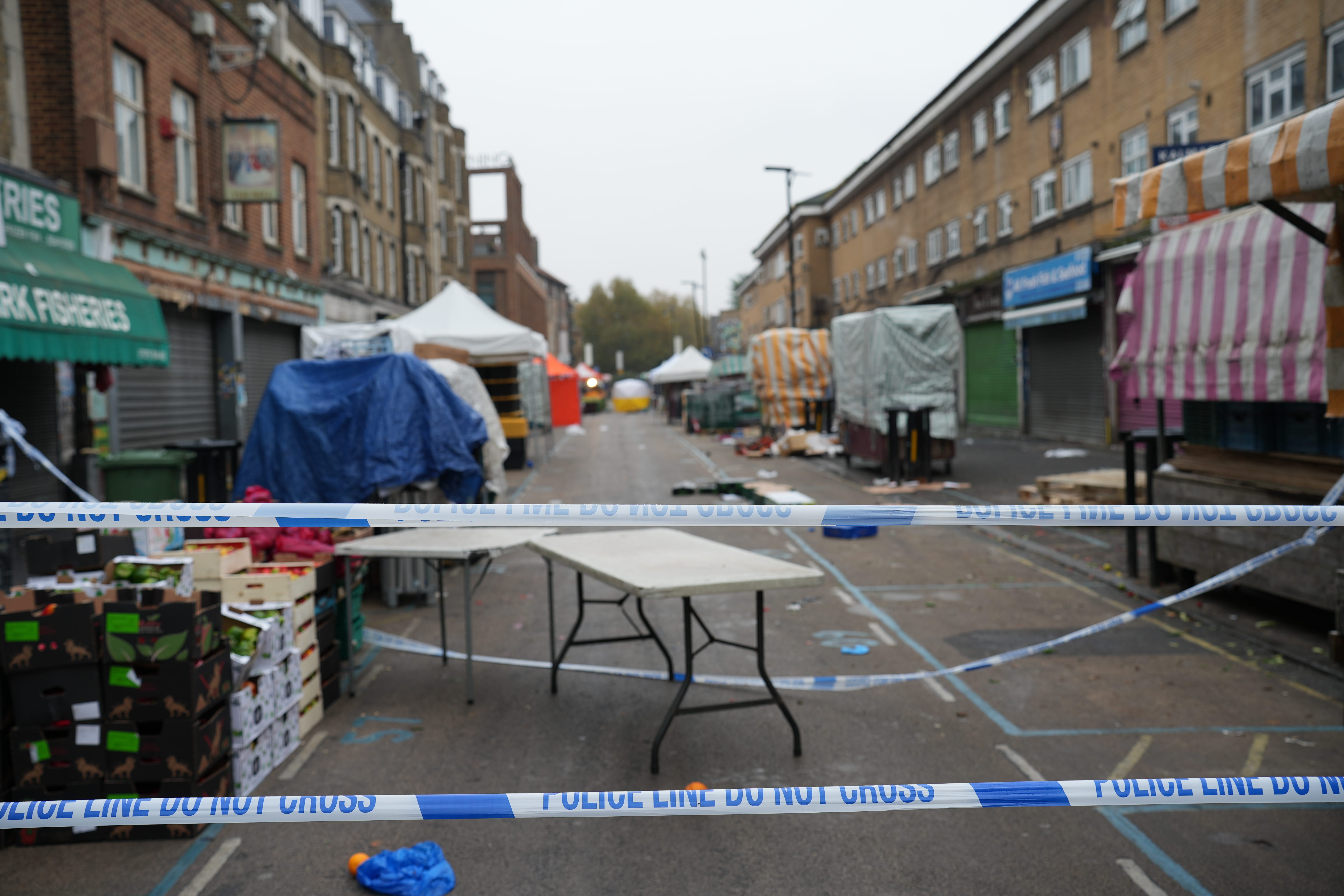 Police at the scene in East Street, Walworth, south London, following a fatal stabbing (James Weech/PA)