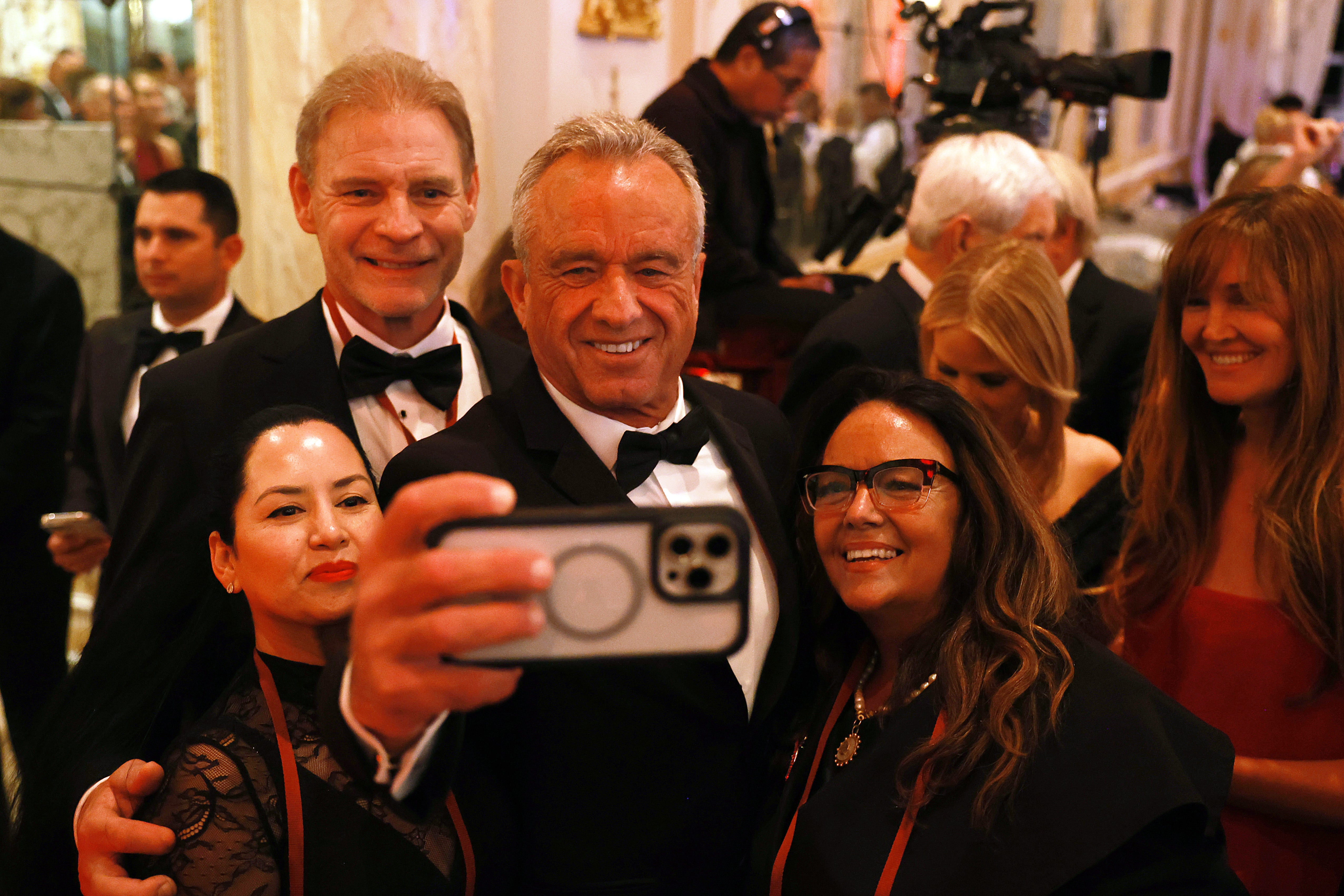 Robert F. Kennedy Jr. takes a selfie with guests at the America First Policy Institute Gala held at Mar-a-Lago on November 14, 2024 in Palm Beach, Florida. Shares in drugmakers dropped following his nomination to lead HHS