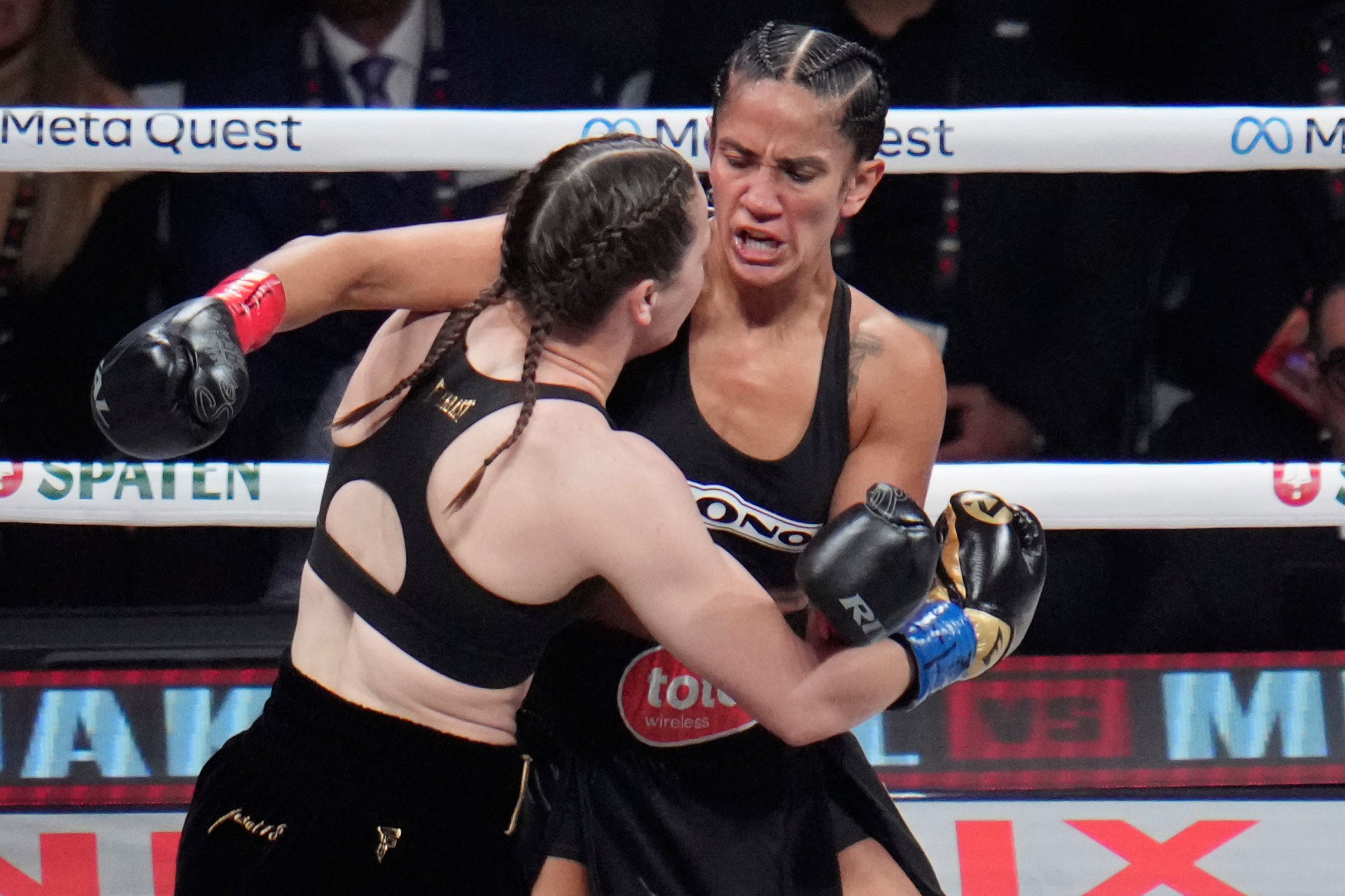 Amanda Serrano, right, and Katie Taylor fight during their undisputed super lightweight title bout on Friday (Julio Cortez/AP)