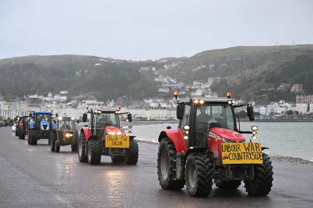 <p>Tractors are driven along the promenade to the venue of the Welsh Labour Party conference in Llandudno</p>