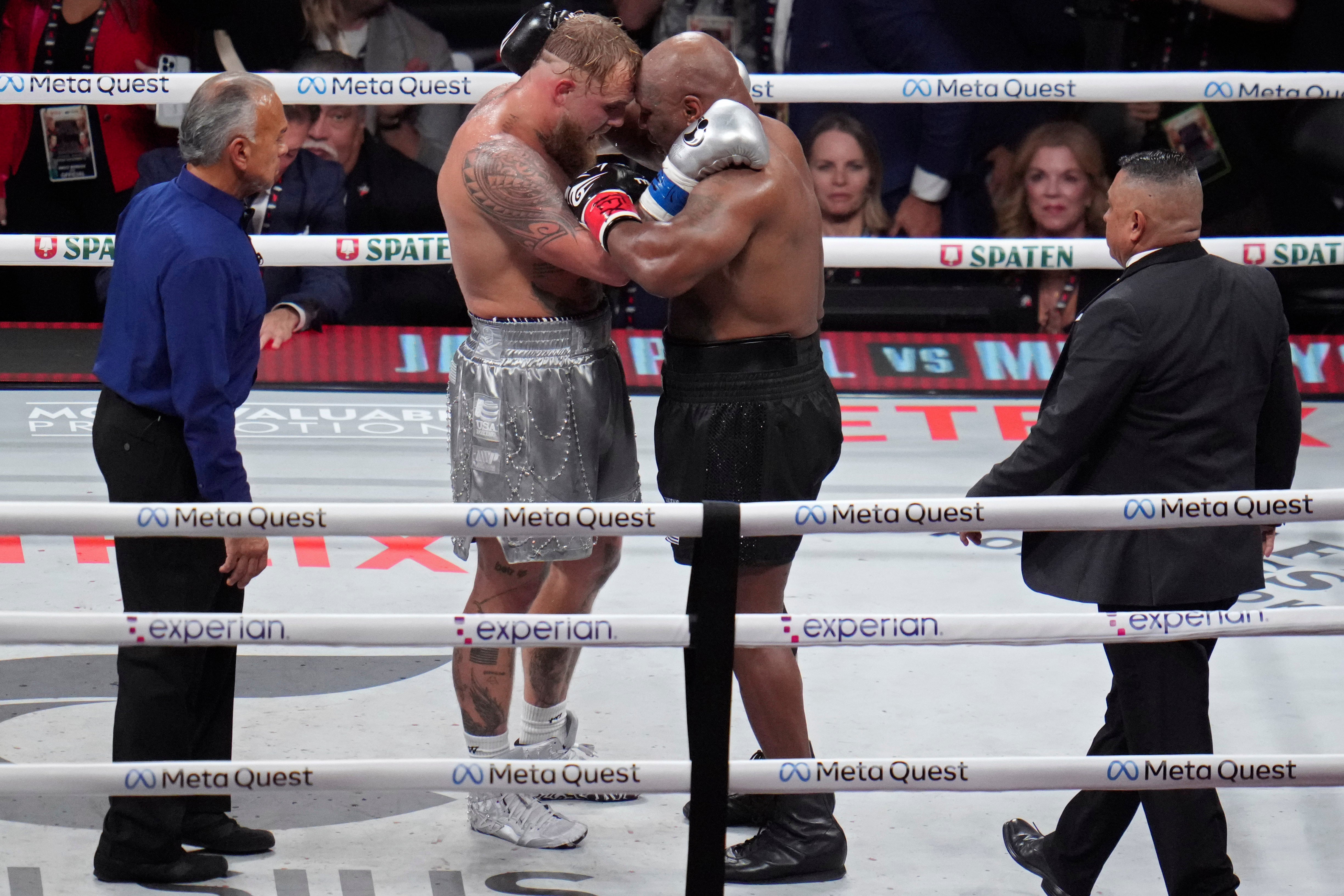 Paul and Tyson embrace after their eight-round fight, in which all rounds lasted two minutes