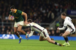 South Africa's Damian de Allende, is tackled by England's Tommy Freeman