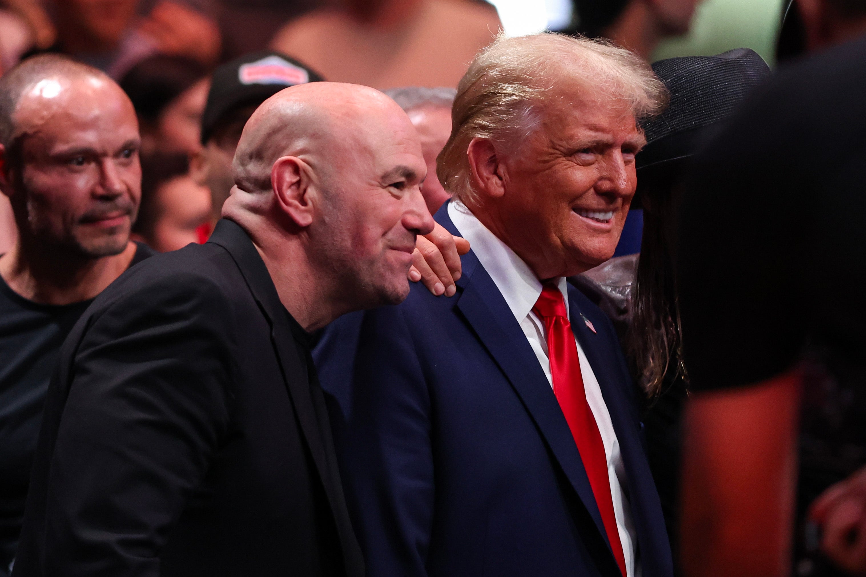 Donald Trump poses for a photo with popular podcaster Joe Rogan