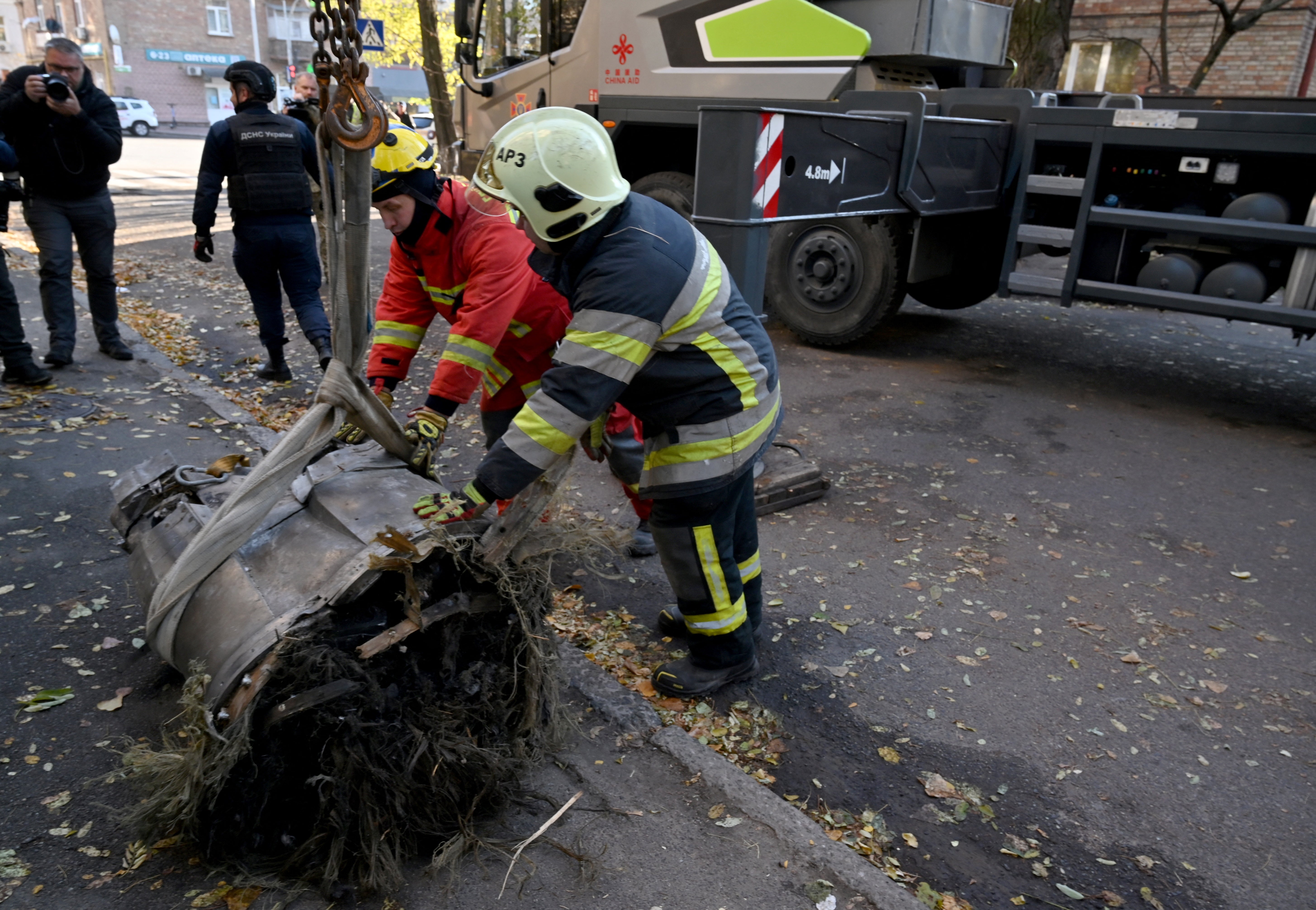 Police experts and rescuers load on a special truck fragments of a downed Russian hypersonic missile Zircon, which felt down on a five-storey residential building in Kyiv in November