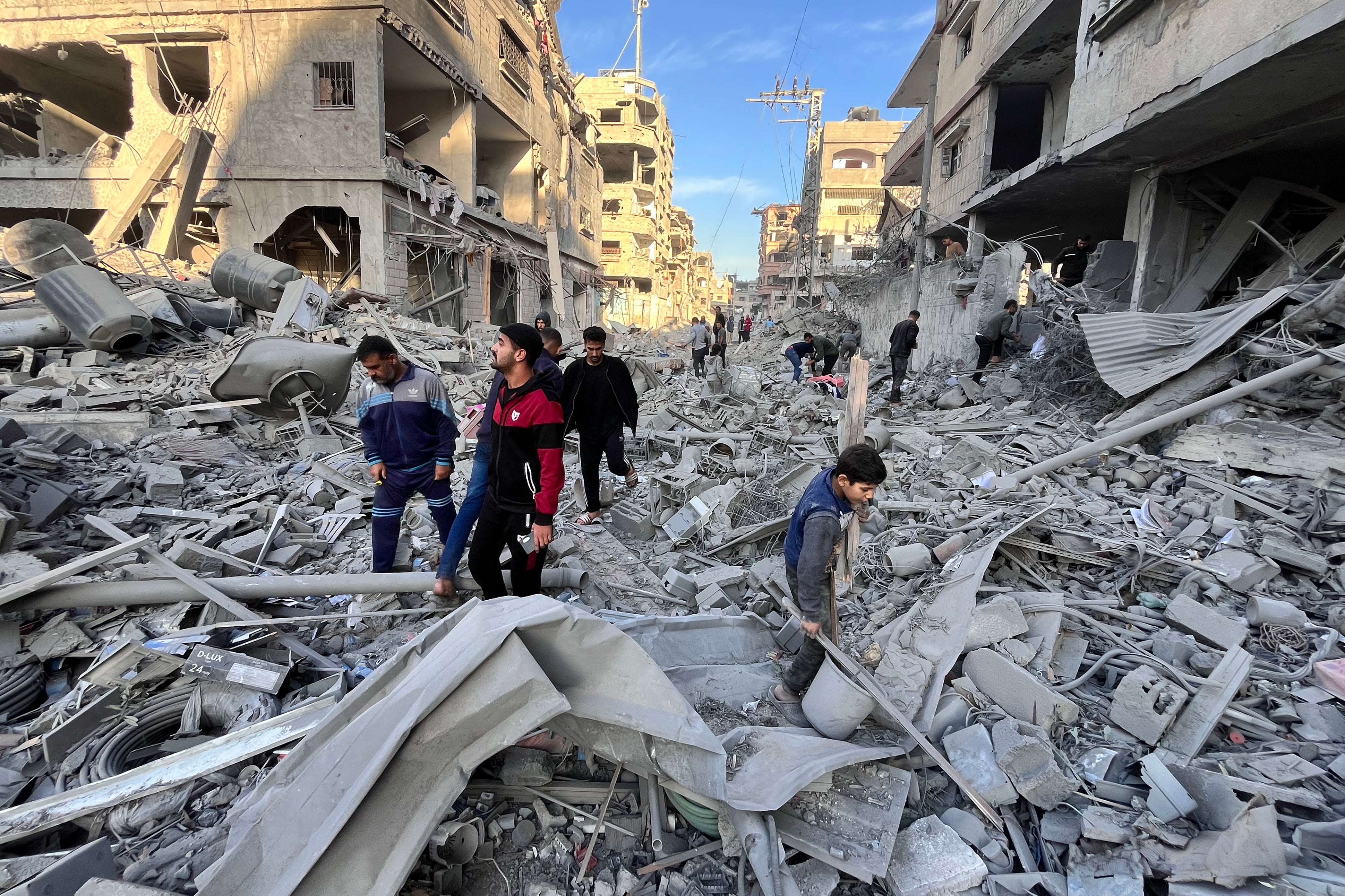 People check the rubble after a devastating overnight Israeli strike in Beit Lahya