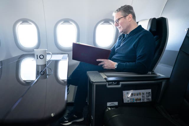 Prime Minister Sir Keir Starmer works on board a Government plane as he travels to Rio de Janeiro (Stefan Rousseau/PA))