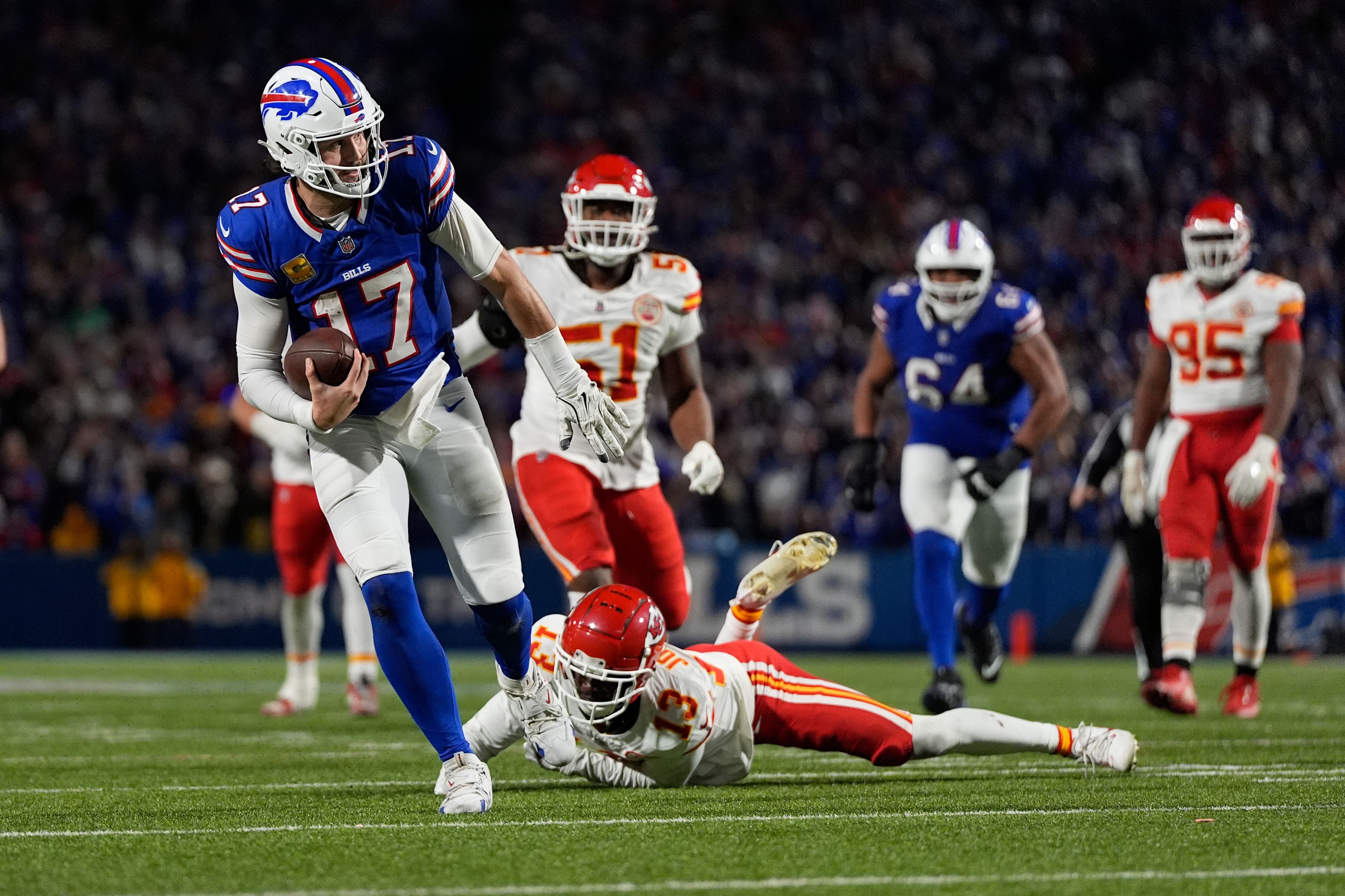 Buffalo Bills quarterback Josh Allen slips past Kansas City Chiefs cornerback Nazeeh Johnson to score on a 26-yard run (Julia Demaree Nikhinson/AP)