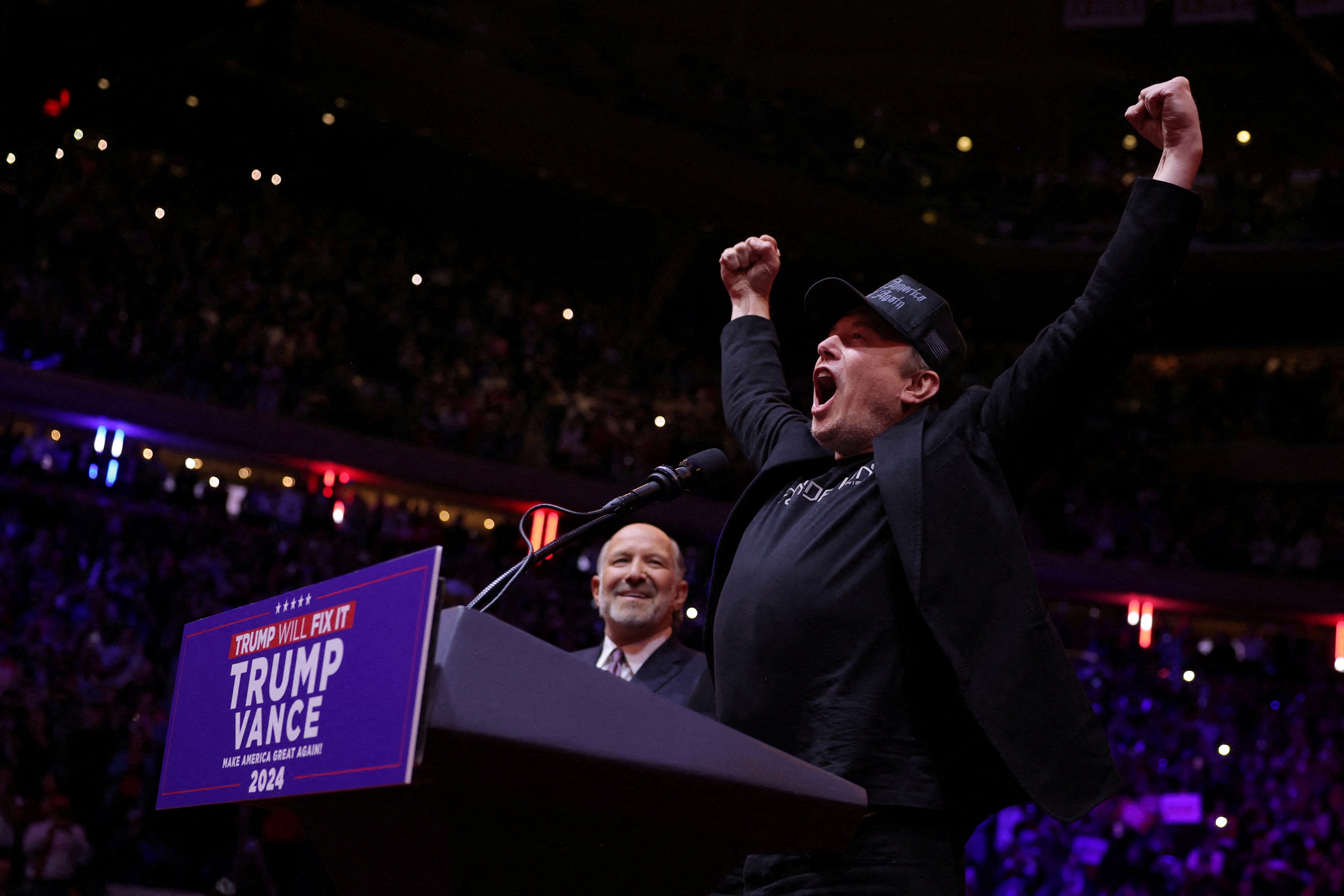 Musk next to Howard Lutnick at a Trump rally at Madison Square Garden, in New York