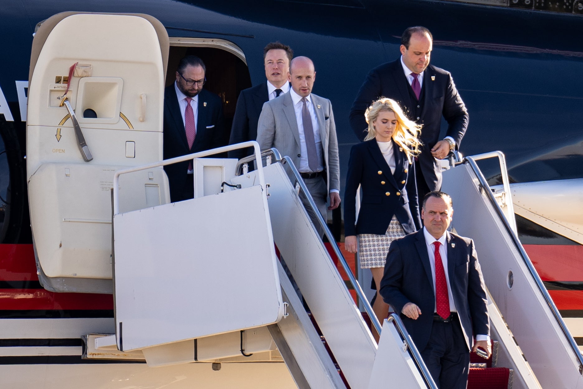 Jason Miller, Musk, Stephen Miller, Boris Esphteyn, Natalie Harp and Dan Scavino arrive with Donald Trump at Joint Base Andrews, Maryland, days after the election