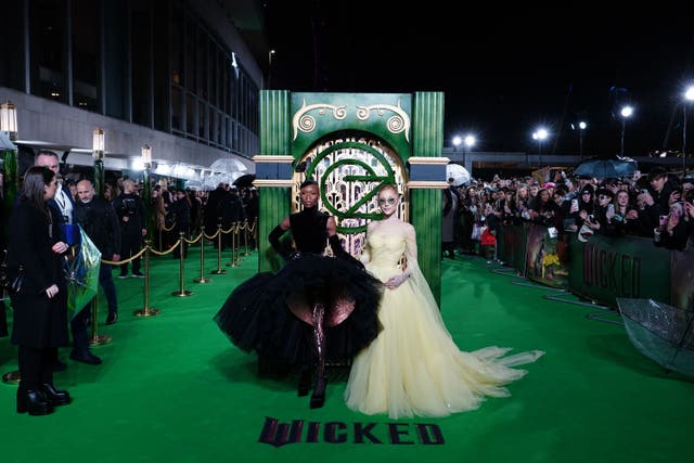 Ariana Grande paid homage to the stage production in a yellow ball gown alongside Cynthia Erivo (Ian West/PA)