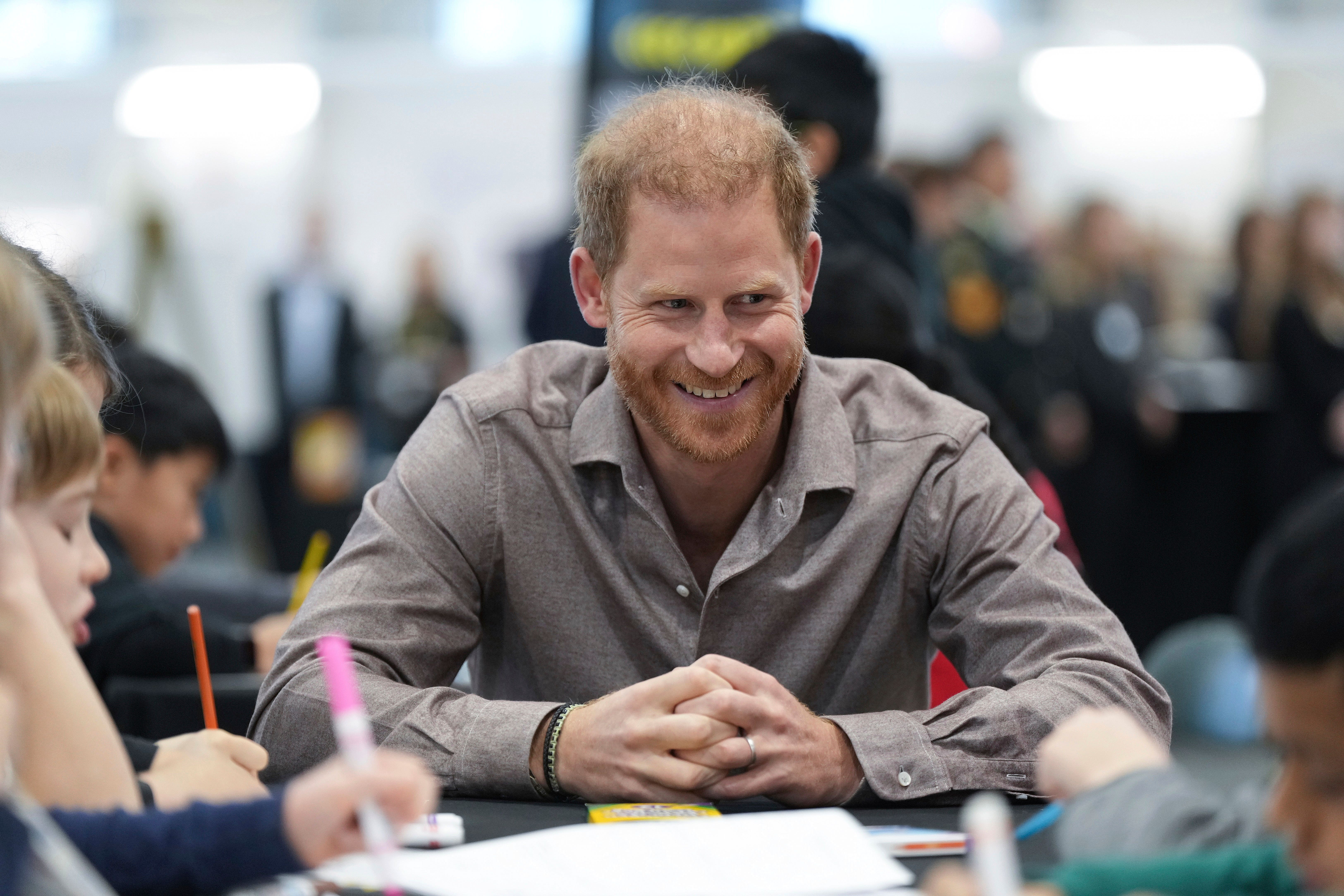 Britain’s Prince Harry, the Duke of Sussex, talks with students from Shaughnessy Elementary School during an event to launch the Invictus Games school program, in Vancouver (Darryl Dyck/The Canadian Press via AP)