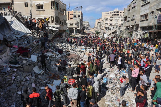 <p>People gather around the rubble of a house destroyed in an Israeli strike in central Gaza City on 18 November 2024</p>