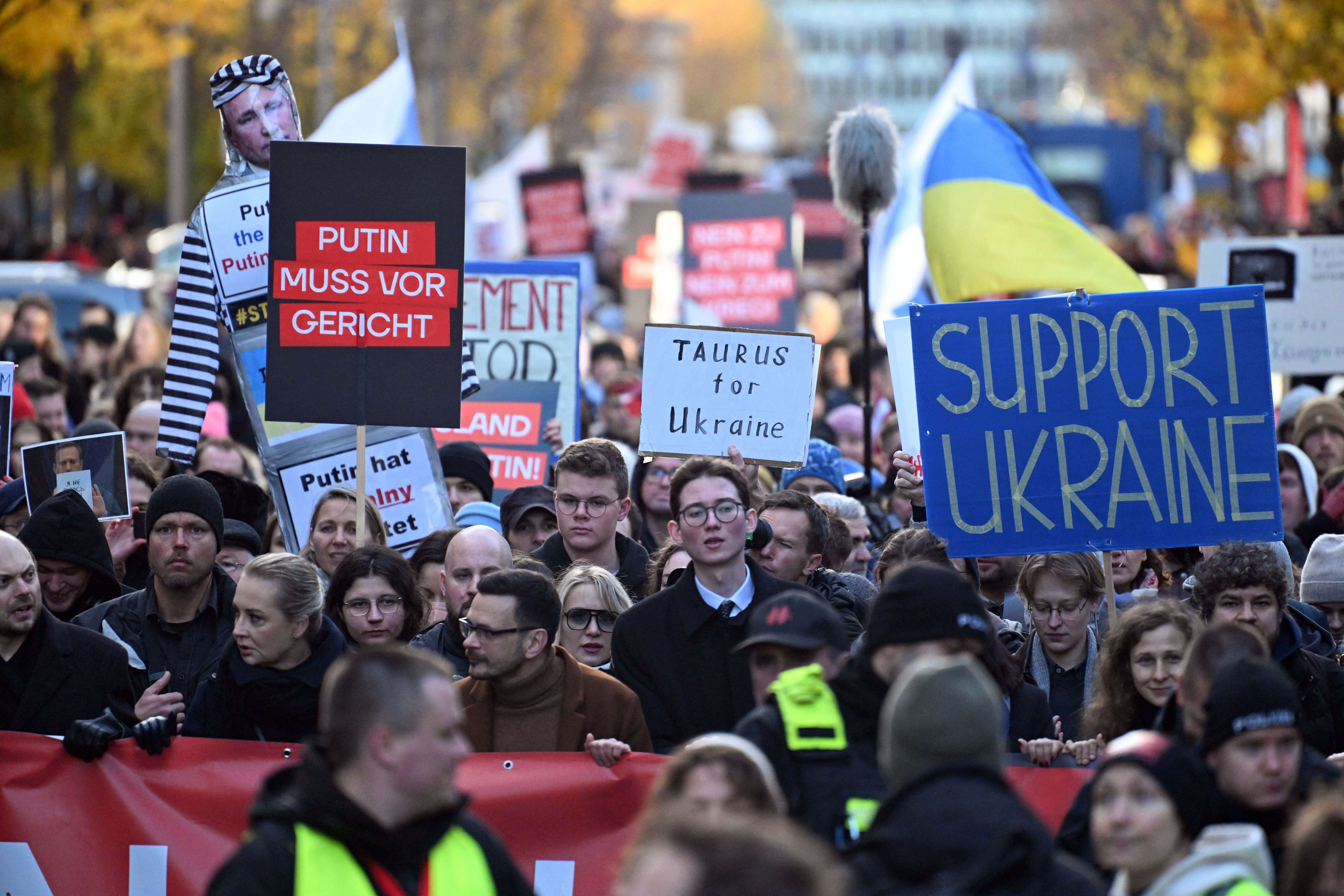 Supporters of Russia’s exiled opposition march with placards in support of Ukraine and against Russian president Putin during a demonstration in Berlin