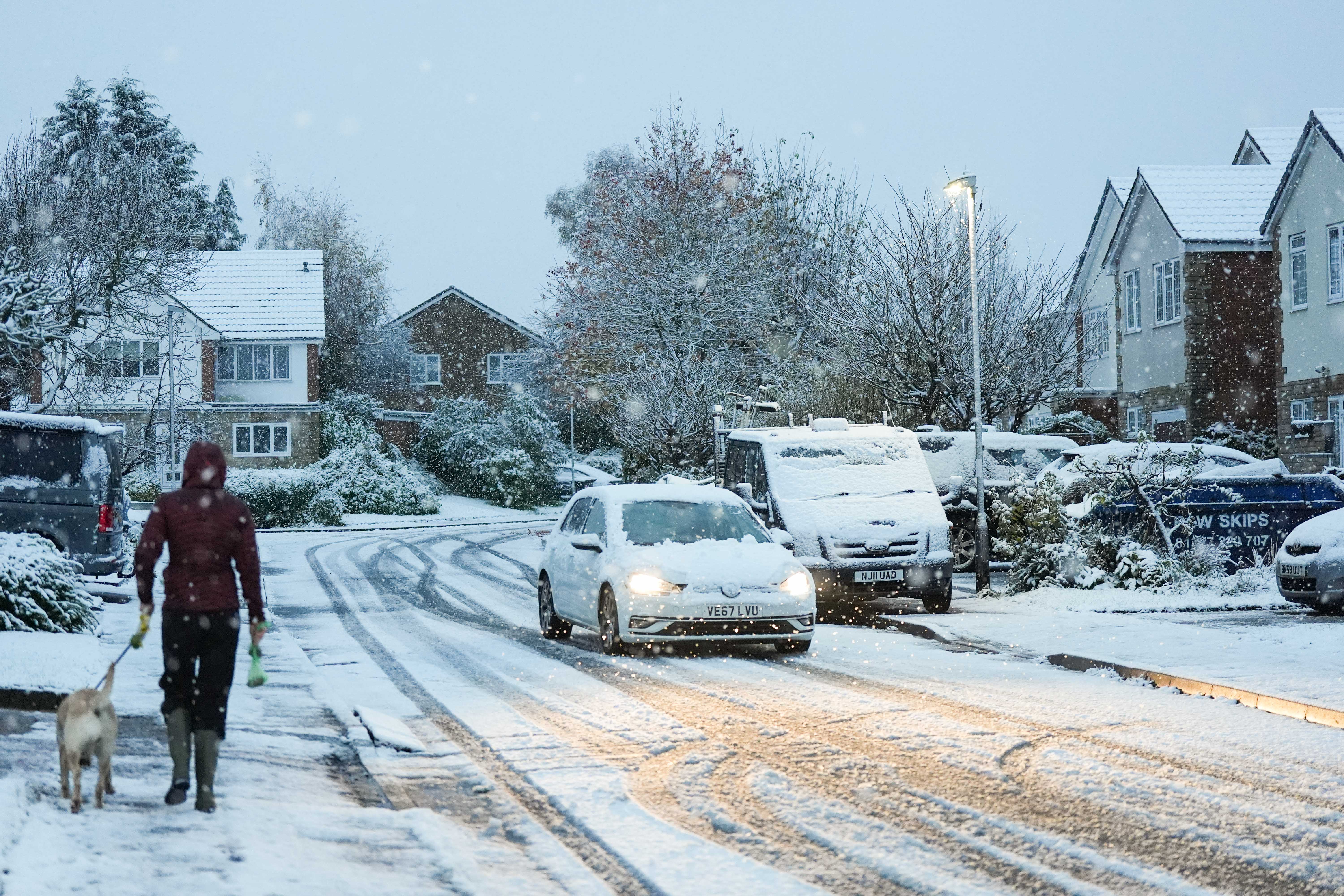 A motorist drives down a snow-covered street in Warwick, Warwickshire