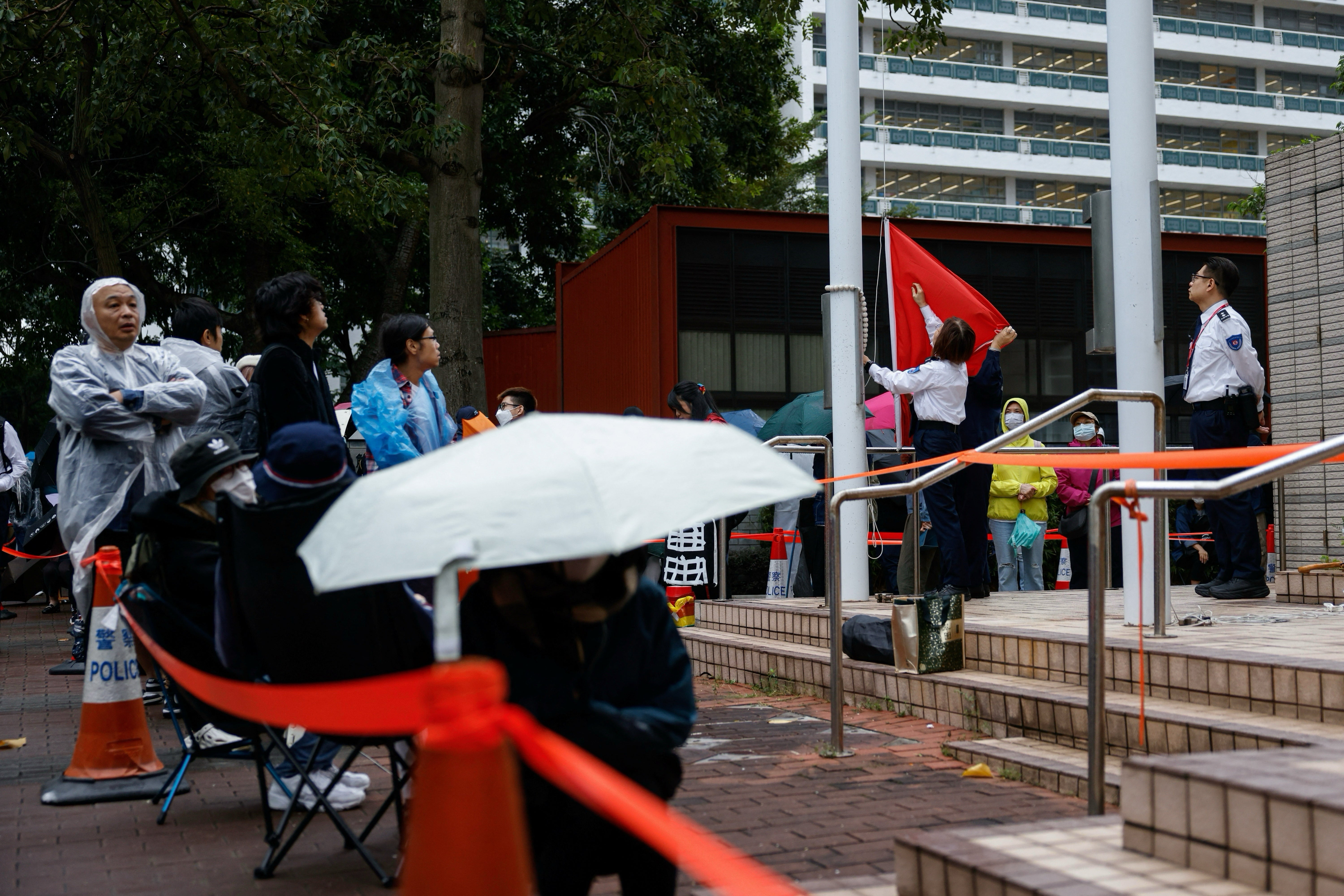 Court unit   rise  a nationalist  emblem  adjacent  to radical   queueing to participate  the West Kowloon Magistrates Court earlier  the sentencing of the 45 convicted pro-democracy activists