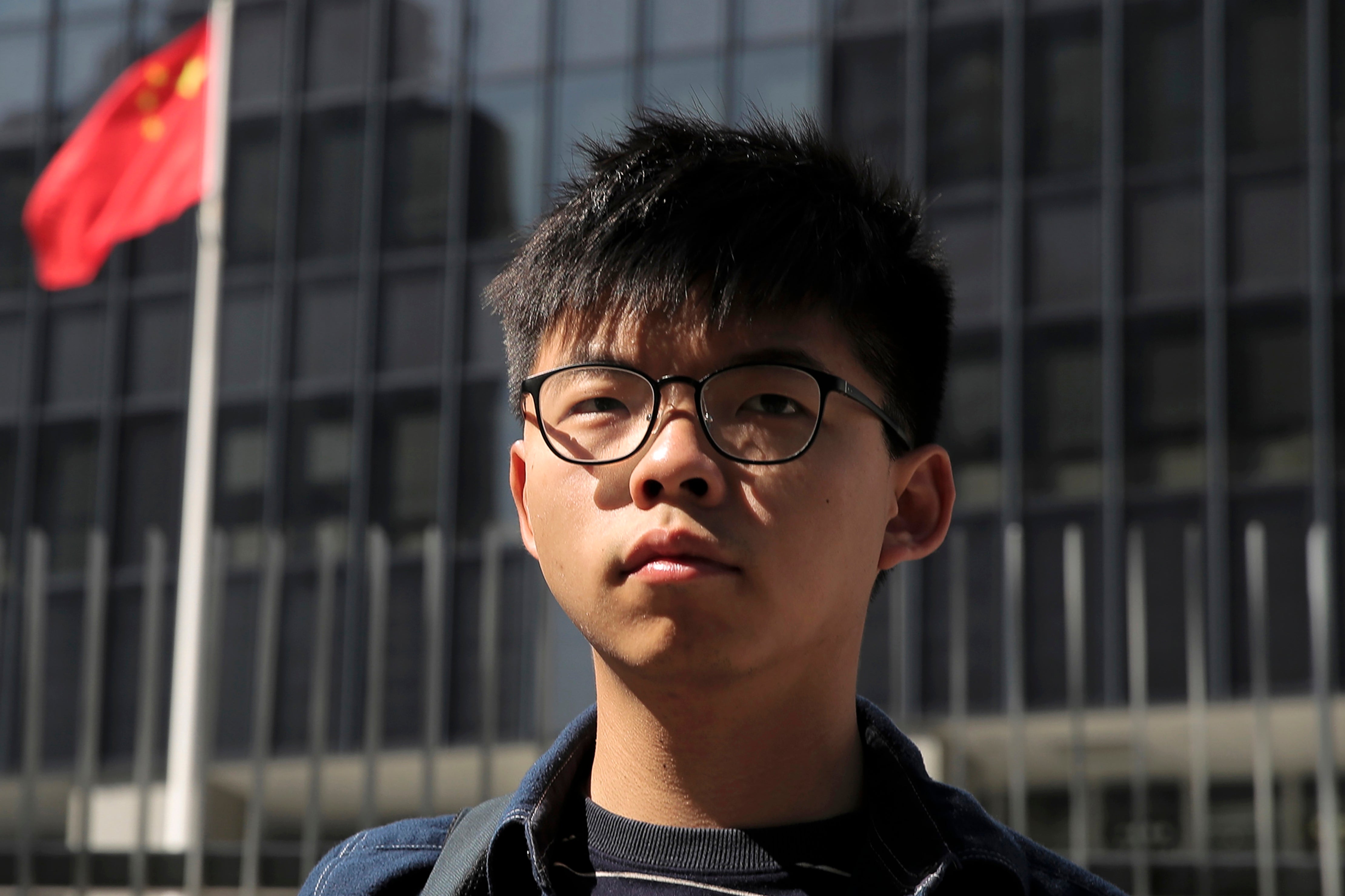 Joshua Wong stands outside the Legislative Council building in Hong Kong on 28 November 2019