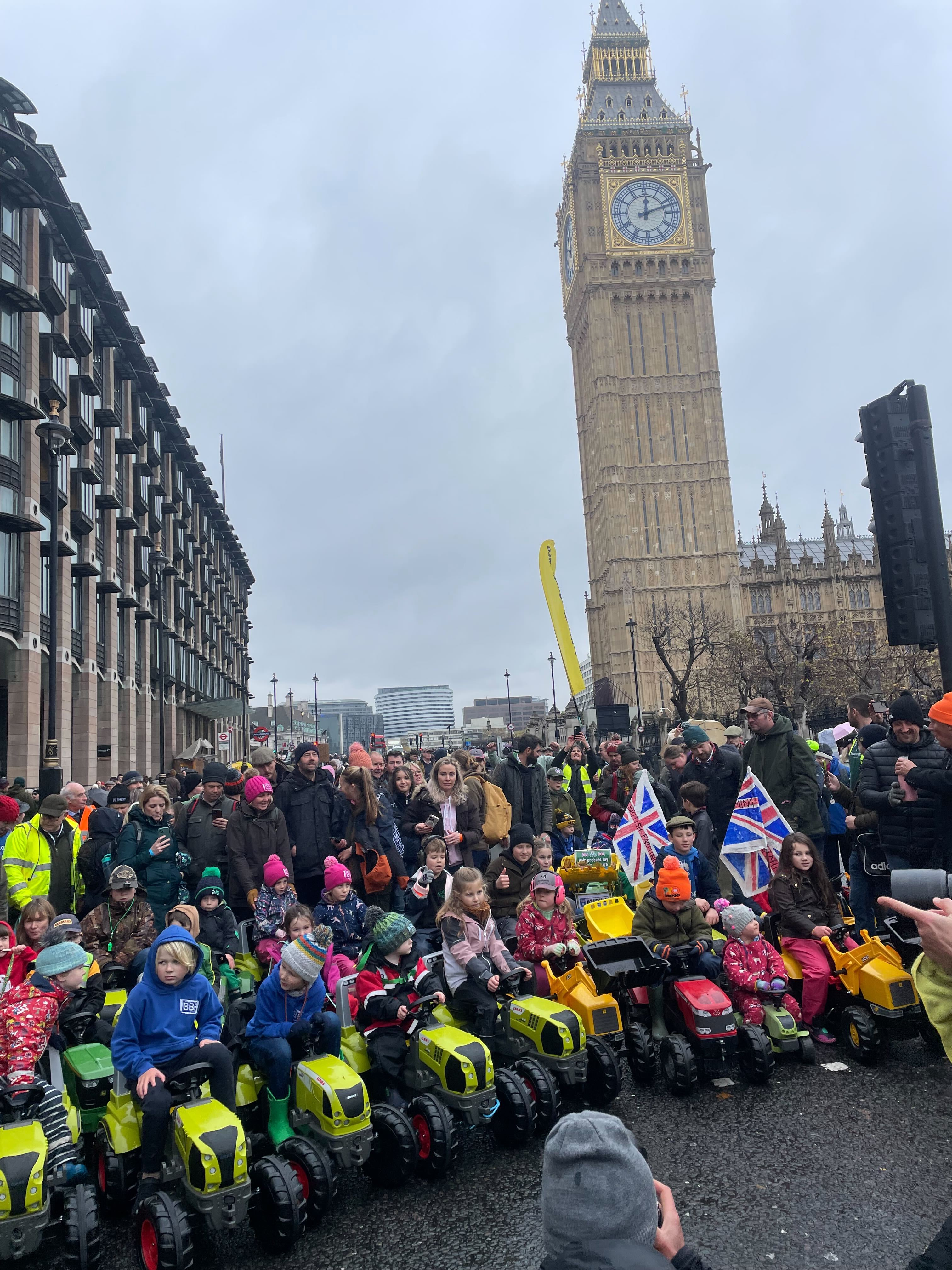 Dozens of young children rode toy tractors around Parliament Square