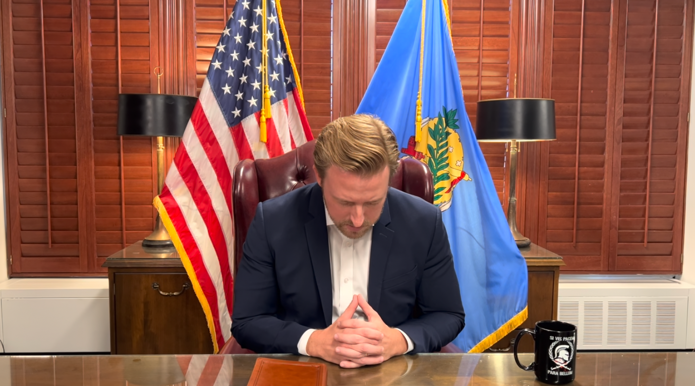 Ryan Walters bows his head in prayer for the president-elect in the video