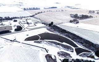 The man-made fish-shaped Muckle Troot Loch near Inverurie, Aberdeenshire, surrounded by snow and ice (Jane Barlow/PA)