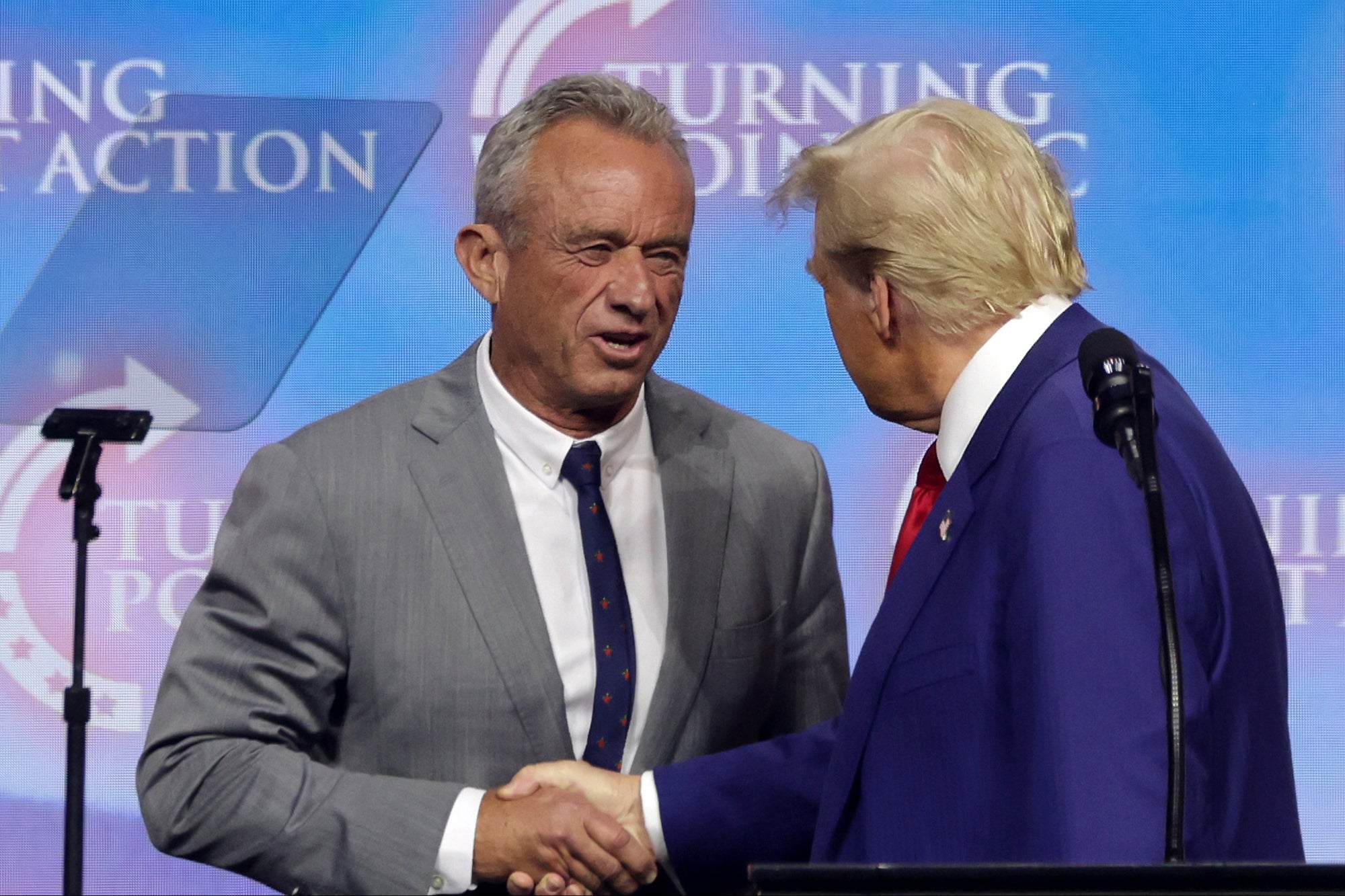 Trump, shakes hands with Robert F. Kennedy Jr. during a campaign rally at Gas South Arena on October 23, 2024, in Duluth, Georgia. Kennedy once suggested that the COVID pandemic may have been planned