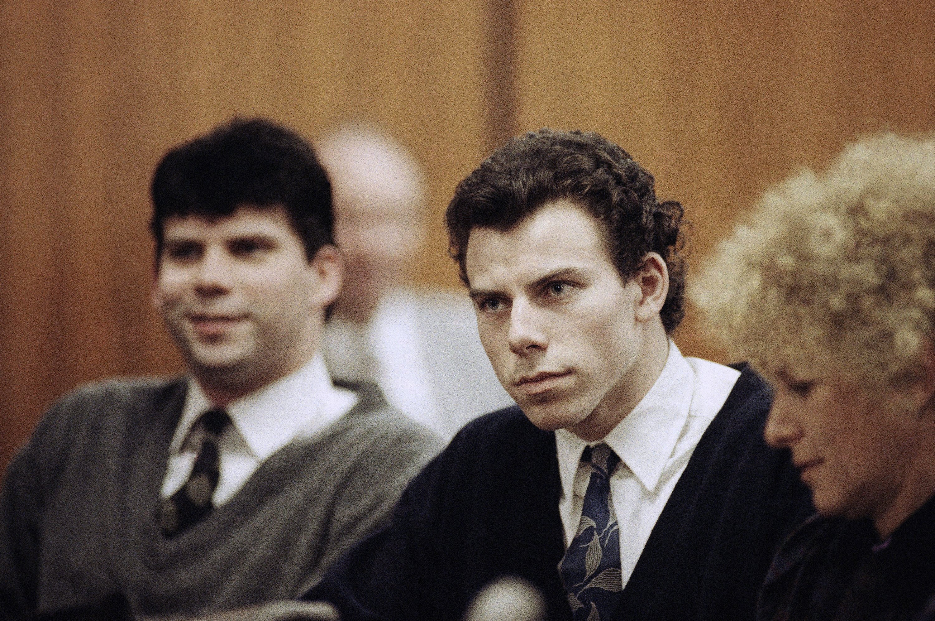 Lyle, left, and Erik Menendez sit with defense attorney Leslie Abramson, right, during a court hearing on November 26, 1990.