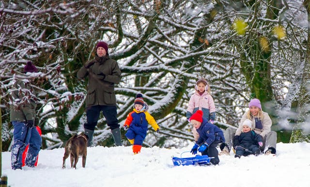 <p>People play in the snow on the hills of Buxton, Derbyshire</p>