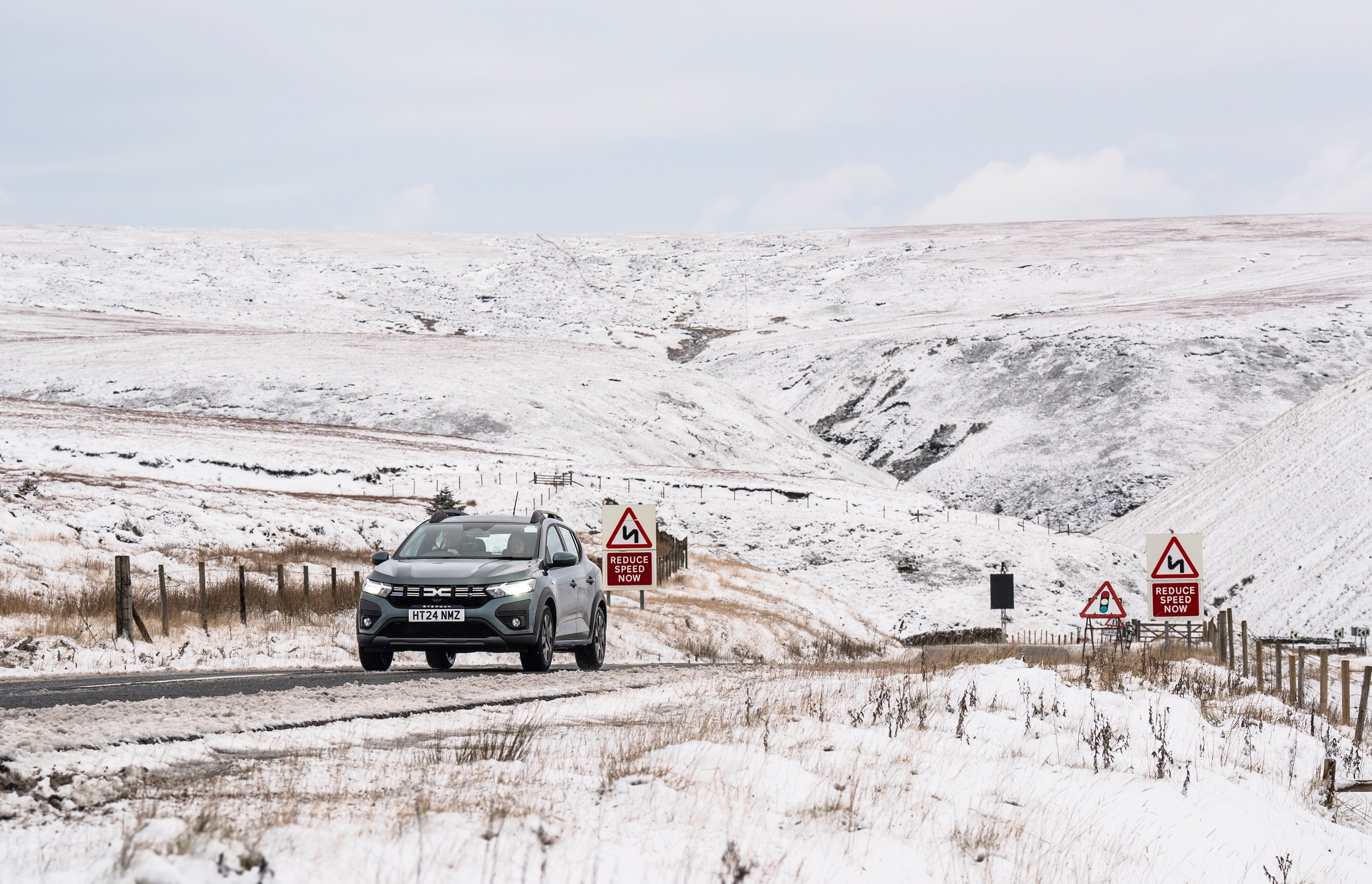 A car navigates the A57 Snake Pass in the Peak District, Derbyshire