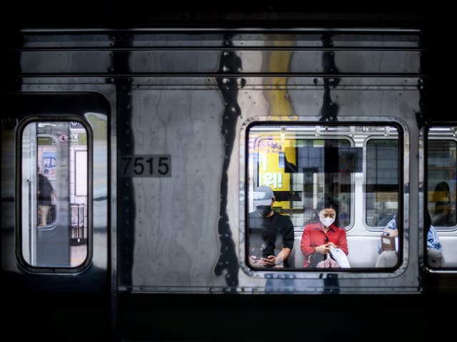 <p>File. Commuters on an underground metro train in Seoul, South Korea </p>