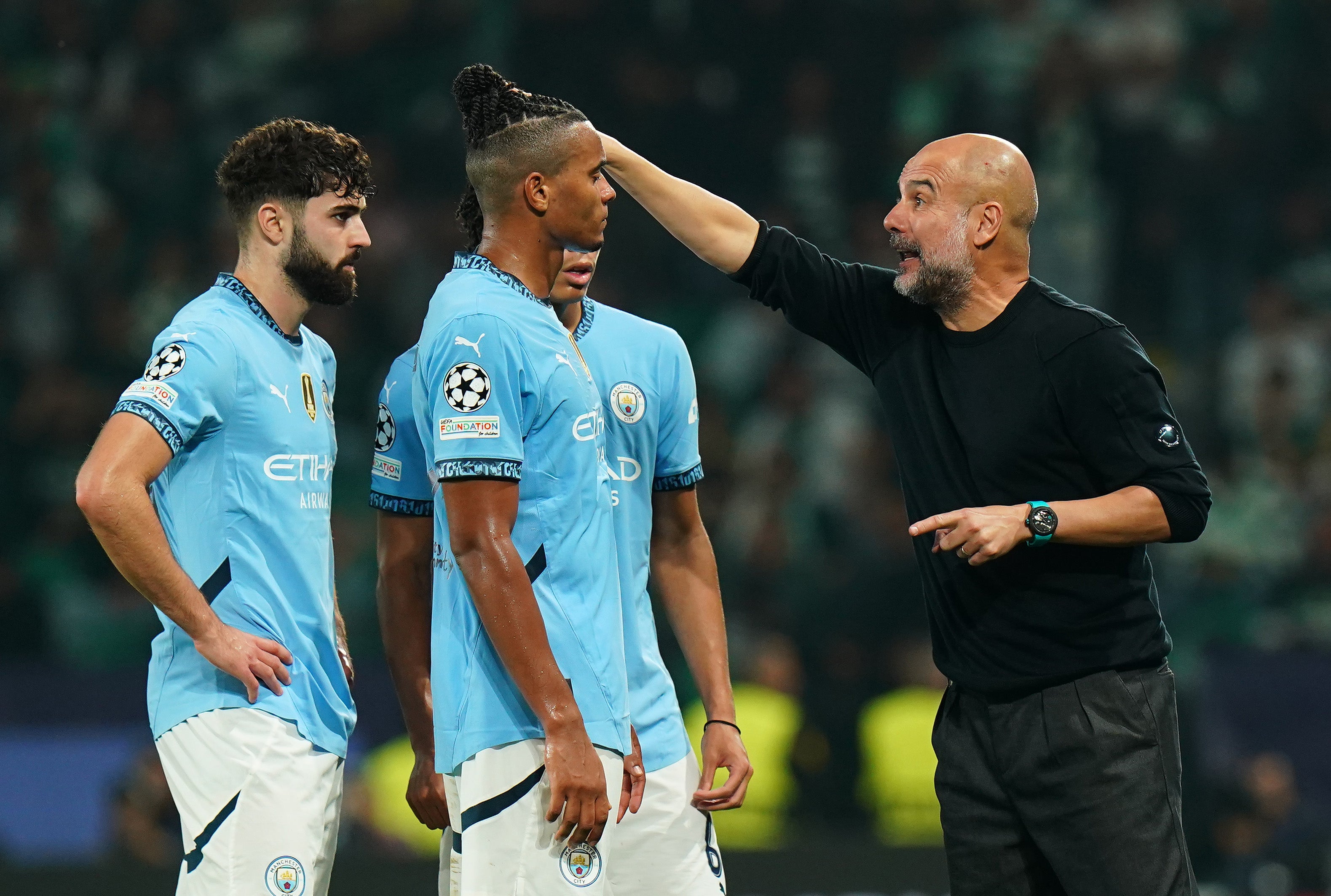 Pep Guardiola in deep discussion with his Manchester City players