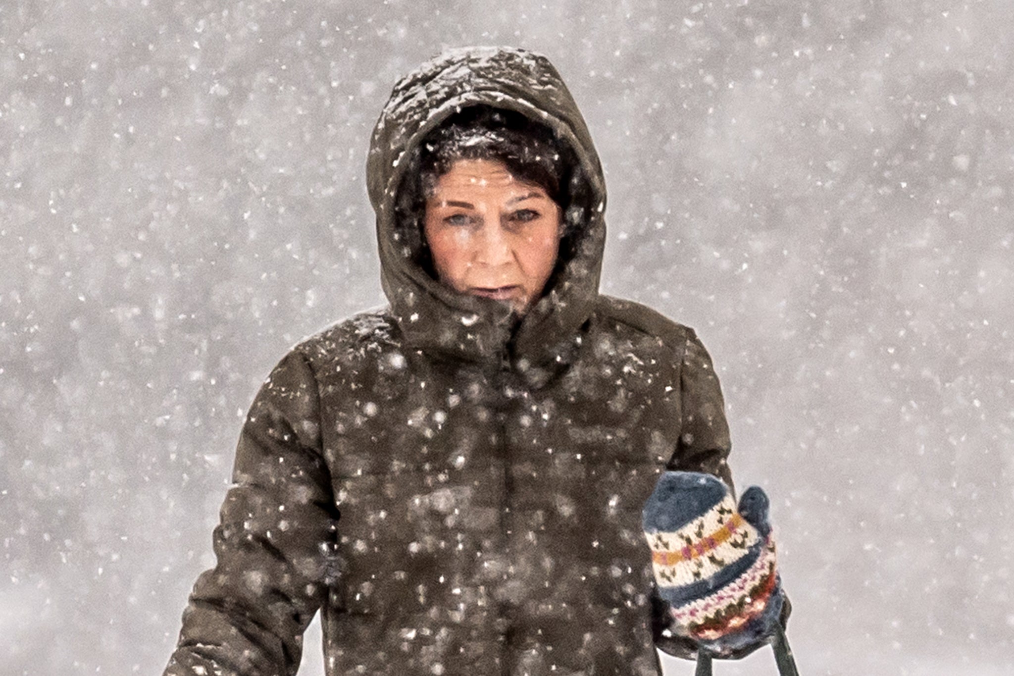 A woman braces the cold weather and snow in Goathland, North York Moors, on Wednesday