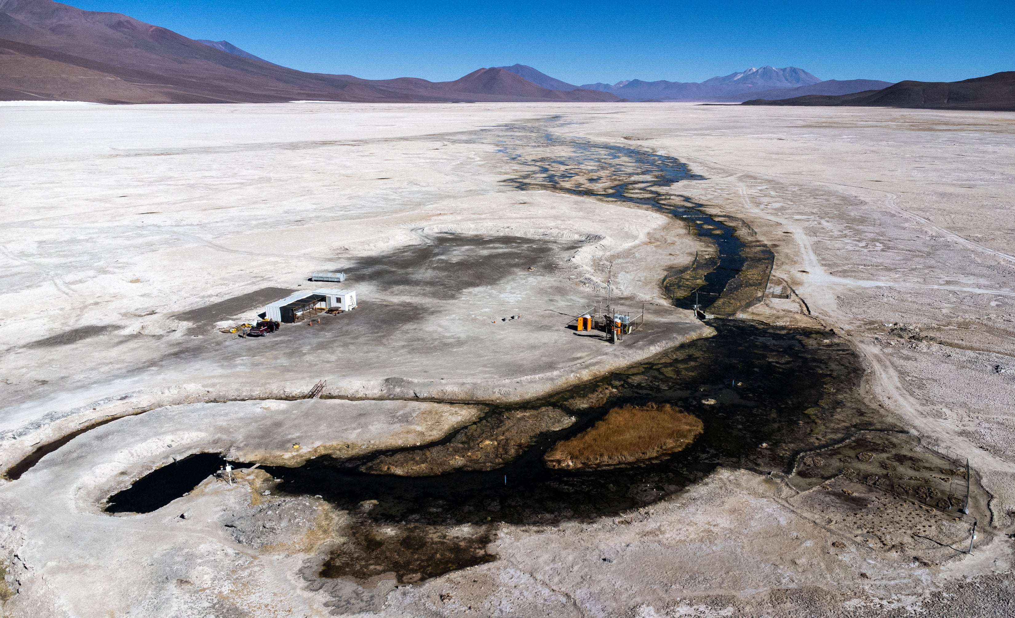 A drone view shows a water source on Ascotan salt flat