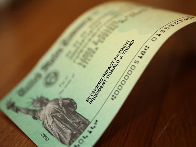 <p>Donald Trump’s name appears on a Covid-19 economic assistance check, one of millions that were sent to Americans at the height of the pandemic</p>