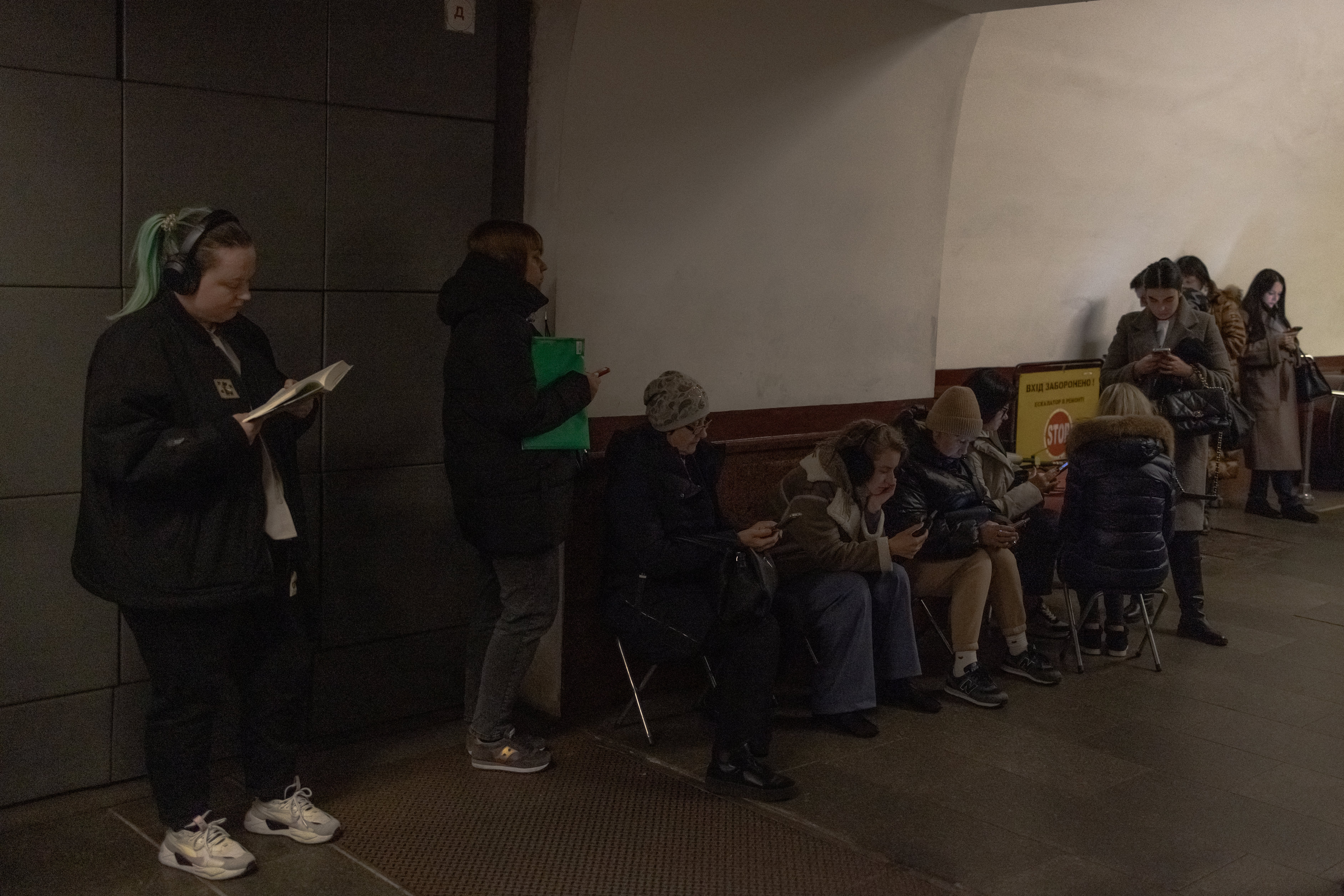 Local residents take shelter in a metro station during an air strike alarm in Kyiv