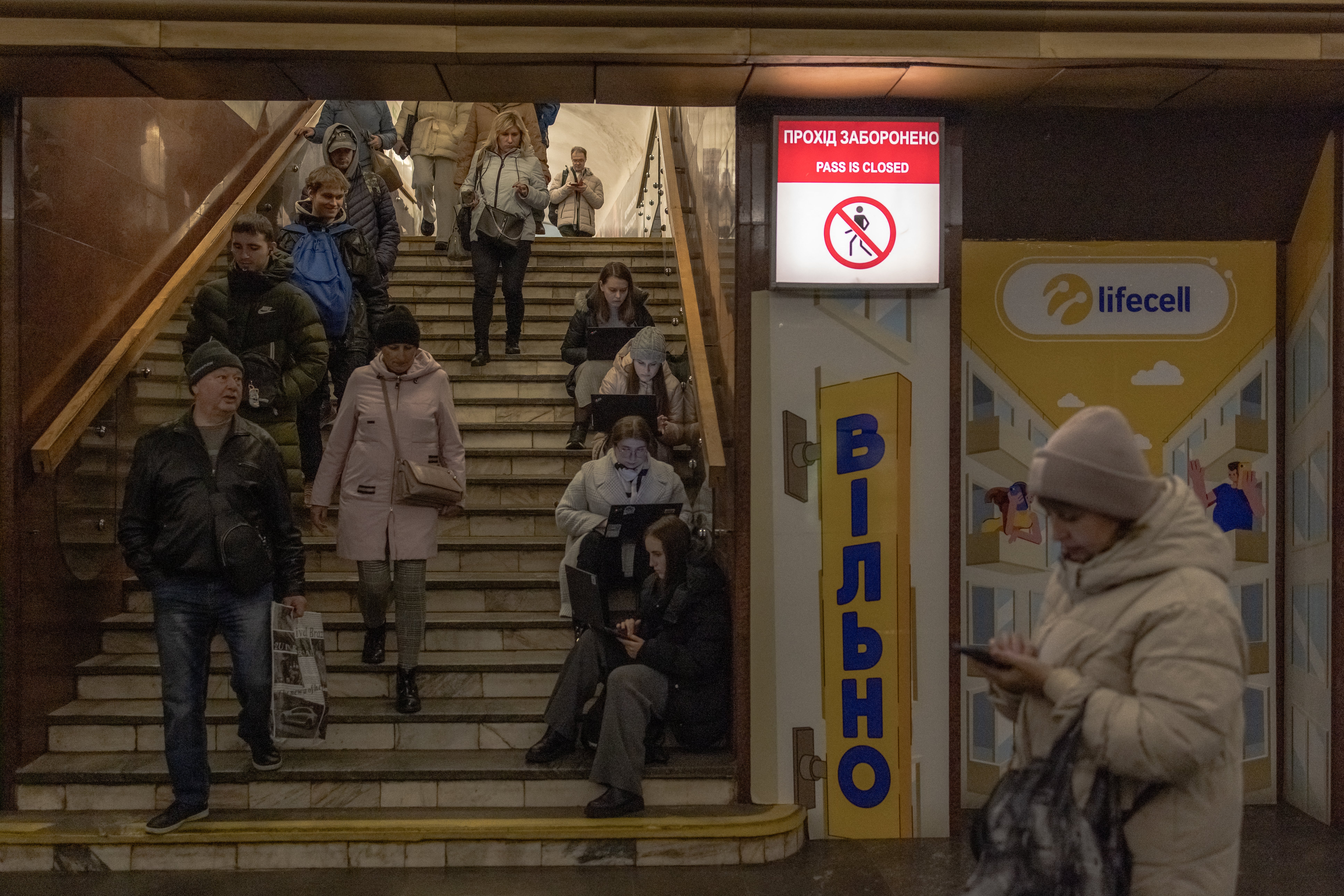 Local residents take shelter in a metro station during an air strike alarm in Kyiv