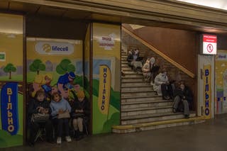 Local residents take shelter in a metro station during an air strike alarm in Kyiv