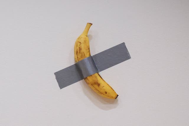 <p>Italian visual artist Maurizio Cattelan's duct-taped Banana entitled "Comedian," displayed during a media preview at Sotheby's in New York, on November 8, 2024</p>