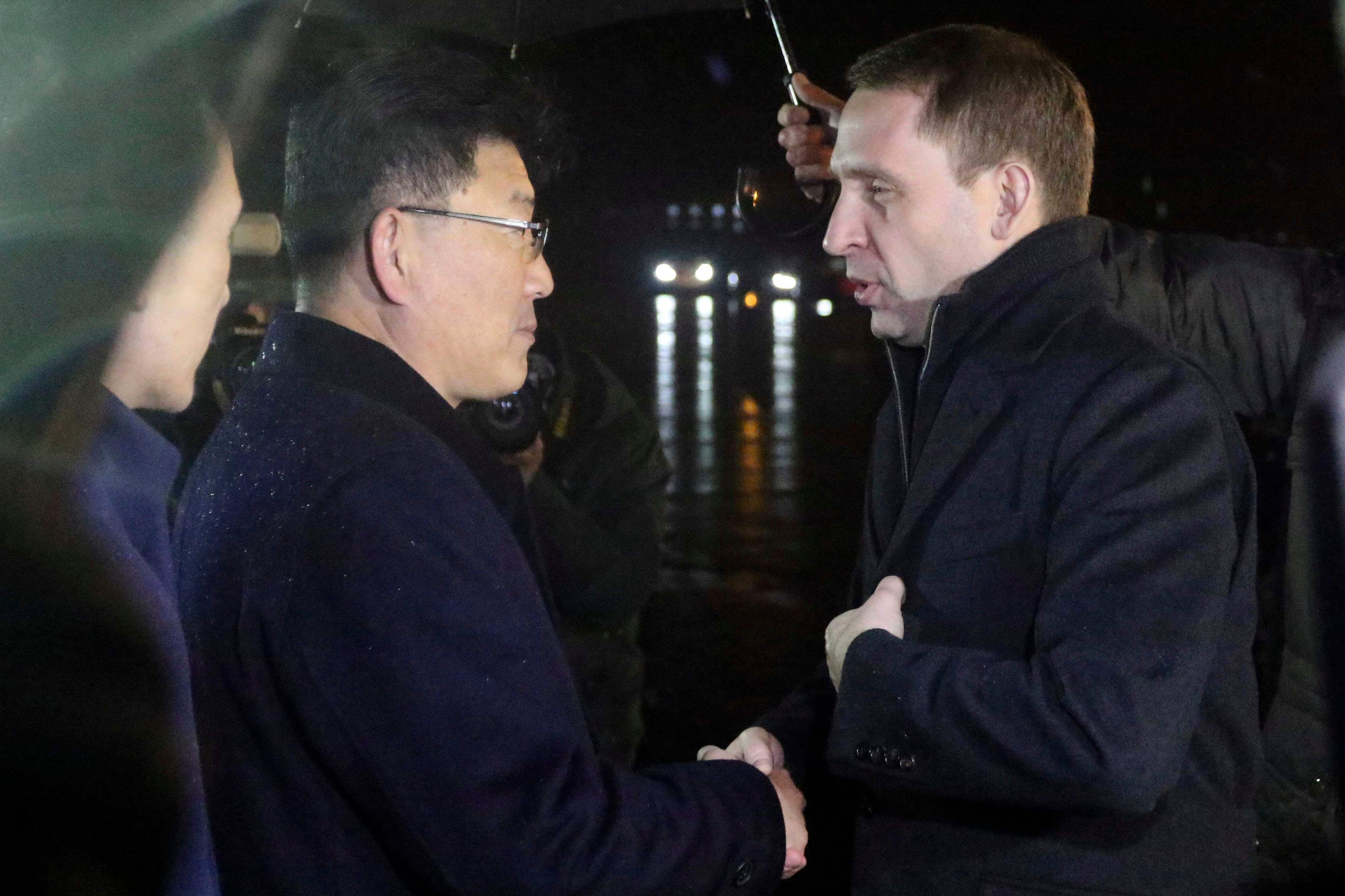 Russia’s natural resources minister Alexander Kozlov, right, is greeted by Yun Jong Ho