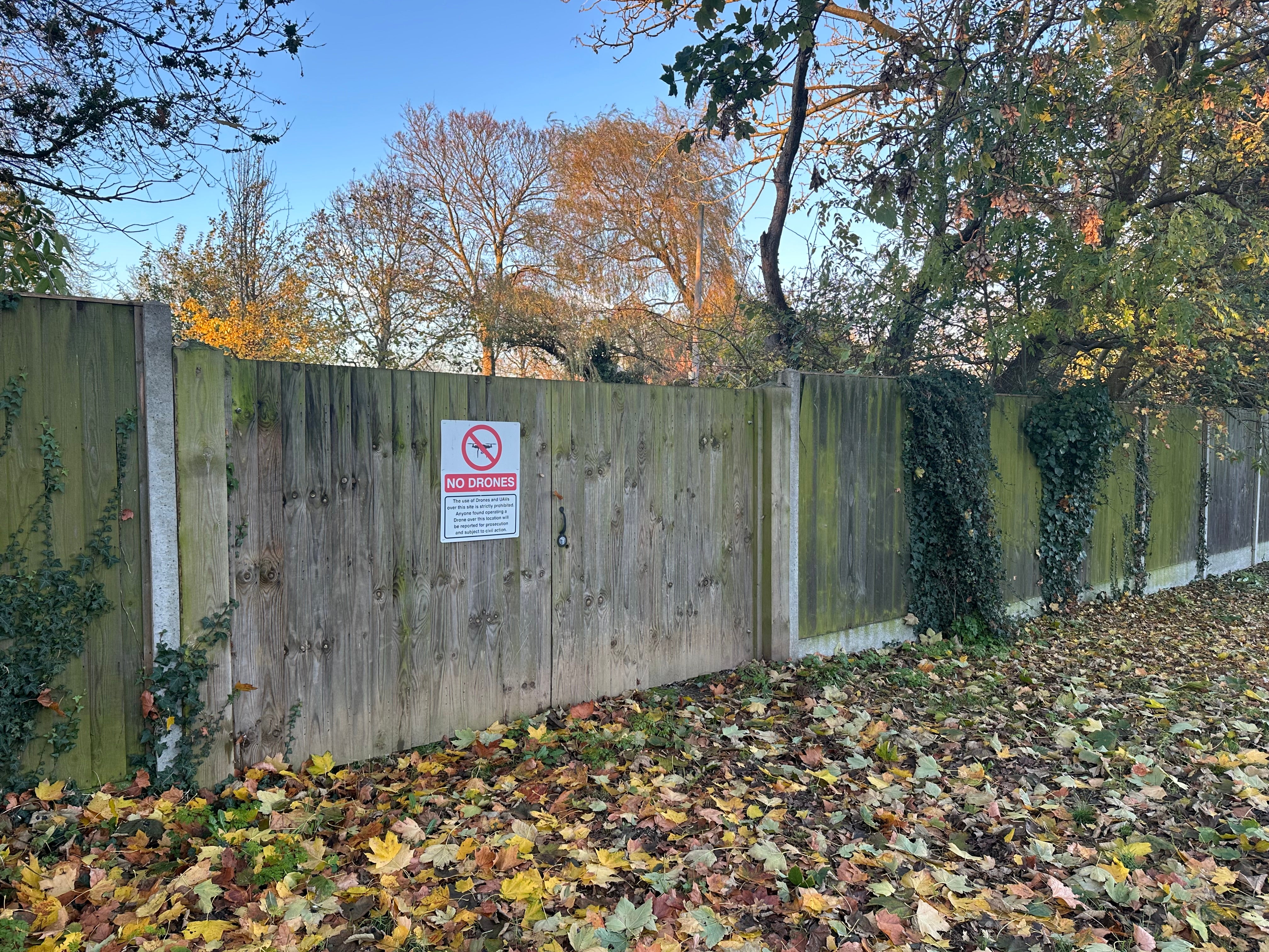 A sign on a fence at the boundary to the back garden of Captain Tom’s home warns people from using drones over the property