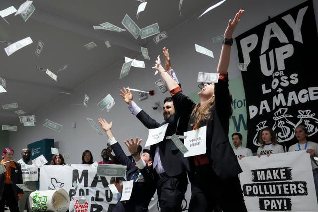 <p>Activists participate in a demonstration for climate finance at the Cop29 UN climate summit (Sergei Grits/AP)</p>