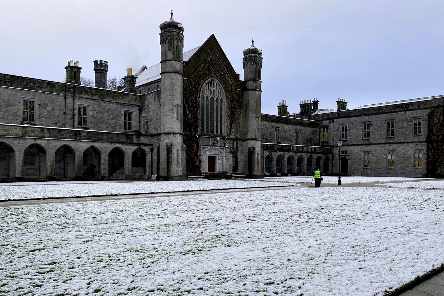 Staff at the University of Galway clear snow from pathways (Sheila Gorham/PA)