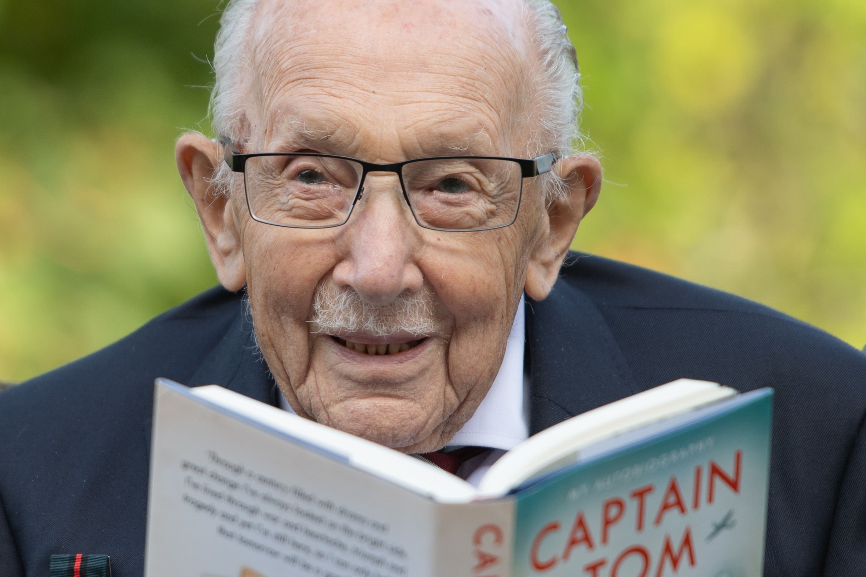 Captain Sir Tom Moore with a copy of his autobiography